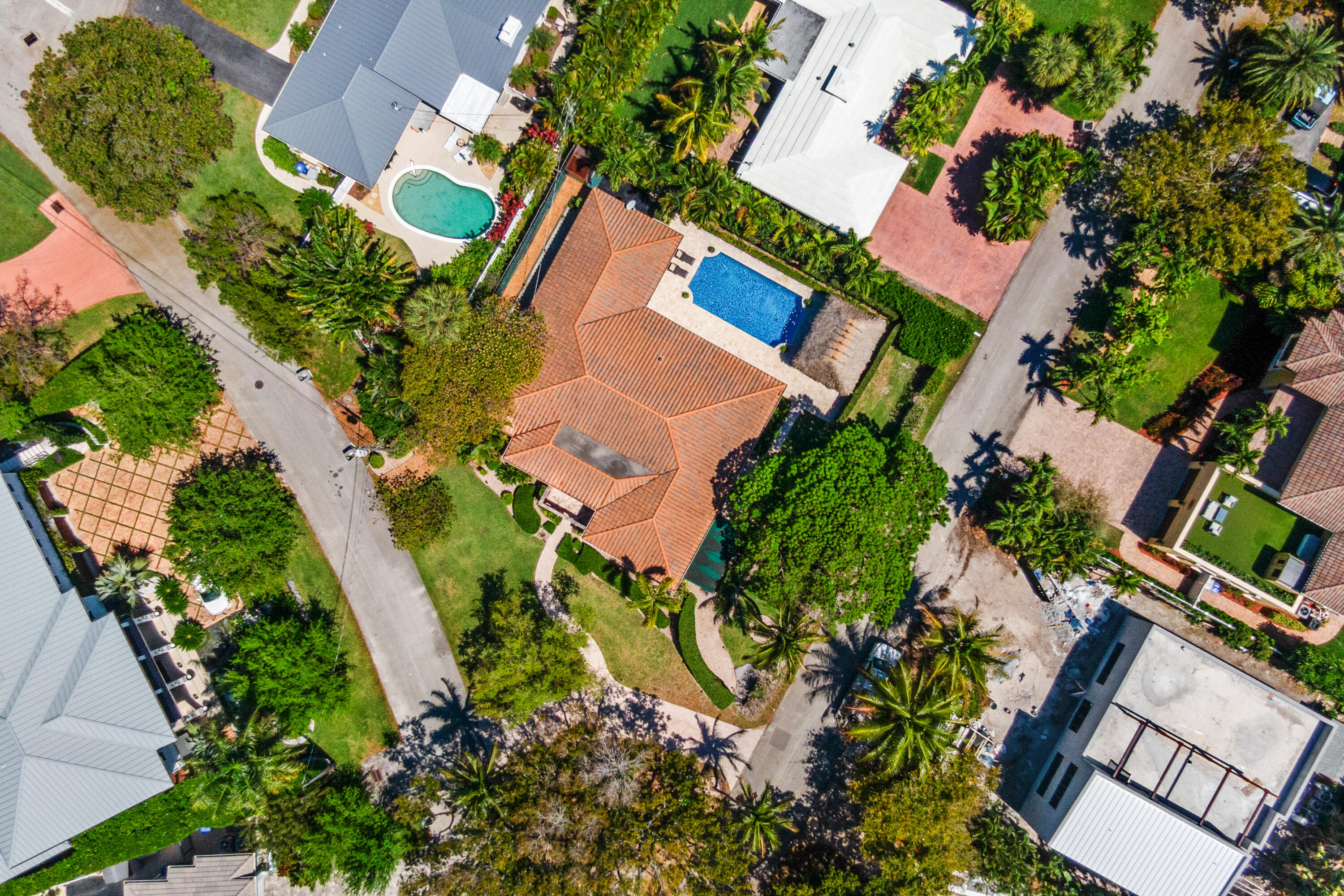 Located just steps from the ocean in the highly sought-after Terra Mar neighborhood, this beautifully appointed 3-bedroom, 3-bathroom home with office and family room offers the ultimate barrier island lifestyle. Situated on a large corner lot with lush, mature landscaping, the property features nearly 3,000 square feet under air and multiple indoor and outdoor living spaces designed for both relaxation and entertaining. Inside, a spacious and inviting layout unfolds with a generous kitchen and dining area that serves as the heart of the home, ideal for hosting gatherings. The thoughtful floor plan includes a dedicated office and separate family room, providing flexibility for work, guests, or additional living space. Outdoor living is a standout feature, with a modern saltwater pool  complete with a water feature and travertine pool deck, creating a private resort-style setting. A fully equipped tiki hut with electricity  including lighting, fan, and TV, enhances the backyard experience, while a front courtyard and multiple seating areas offer additional spaces to unwind. Enjoy the convenience of a true coastal lifestyle, Terra Mar Island is a gated waterfront community of approximately 140 single-family homes, located right off A1A. The surrounding area features sidewalks throughout, making it easy to walk or bike to the beach or into Lauderdale-by-the-Sea for restaurants, shops, and nightlife. With only one way in and out, traffic stays light and the community maintains a quiet, residential feel. For boating enthusiasts, multiple nearby public boat ramps and marinas provide convenient access.  The location is also highly accessible for commuters: approximately 20 minutes to FTL Airport, 40 minutes to MIA, and 1 hour to PBI Airport. Terra Mar is a great option for buyers looking for a laid-back coastal lifestyle with beach access, walkability, and a true neighborhood feel. This is a rare opportunity to own a spacious home in one of the area's most desirable ocean-close communities.