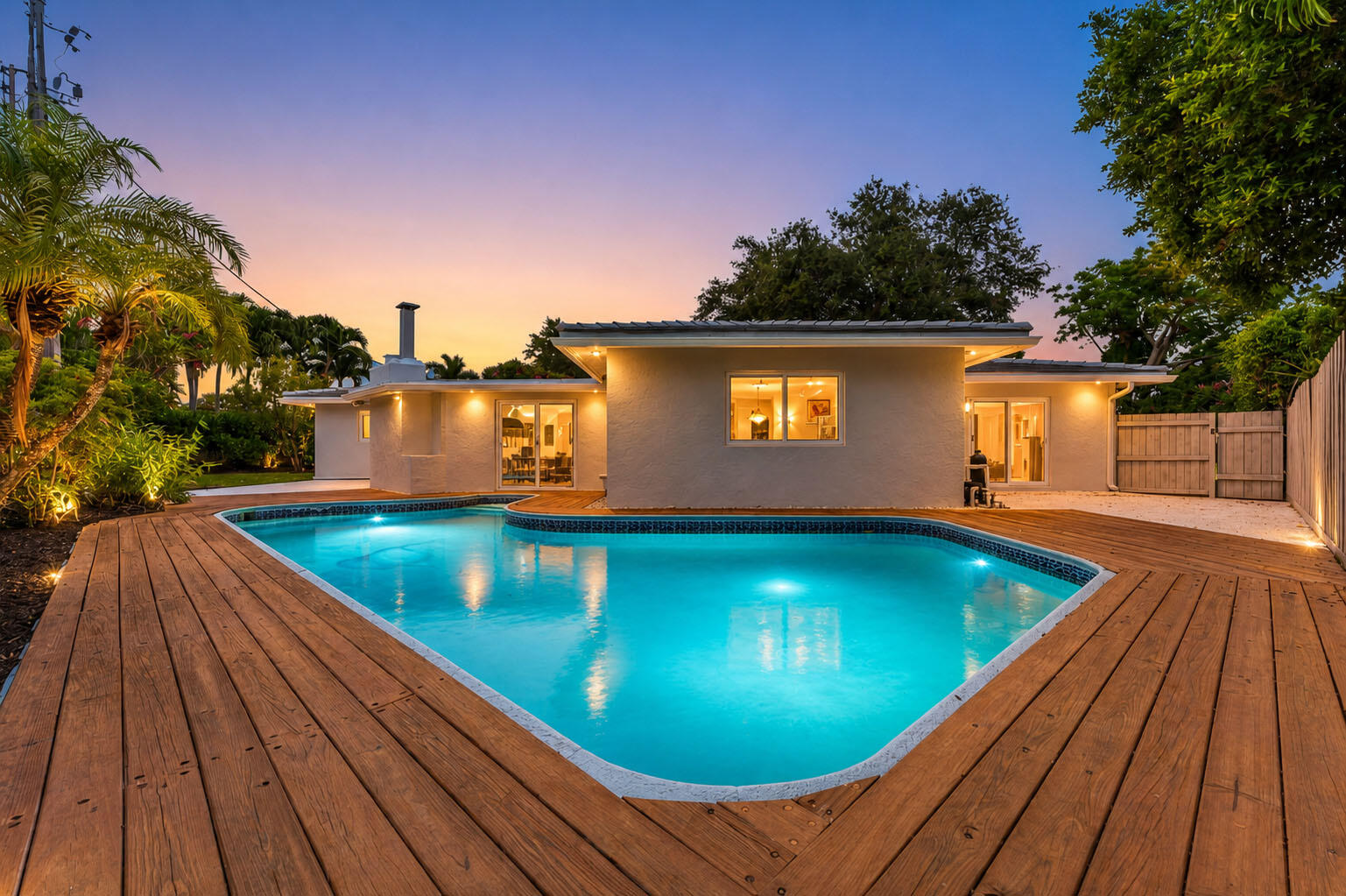 Located in the prestigious Coral Ridge Country Club, this 3-bedroom, 3-bathroom pool home sits on a nearly ¼-acre lot situated in minute's proximity to some of the best restaurants and amenities that Fort Lauderdale has to offer! Built in 1957, this 2,617 SQ FT home features a desirable split-floor-plan layout with two master suites and walk-in closets in every bedroom.  A lushly landscaped front yard and huge circular driveway lead to the newly painted exterior and modern front door. Inside, beautiful arch entryways connect two generous living spaces: a formal living room and a cozy sunken family room with electric fireplace. The eat-in kitchen offers wood cabinets and abundant natural light, complemented by new lighting. Additional conveniences include (see more)...  a dedicated laundry/utility room and a full 2-car garage.  Key upgrades include a 2022 roof, impact windows and doors, 2018 A/C system, 2021 water heater, and new pool equipment. The private fenced backyard features a saltwater pool, wood deck, and covered patio ideal for indoor-outdoor living.  This prime East Fort Lauderdale location offers easy access to golf, tennis, and club amenities, while being minutes to beaches, the Intracoastal Waterway, parks, dining, nightlife, grocery stores, and the Galleria Mall.