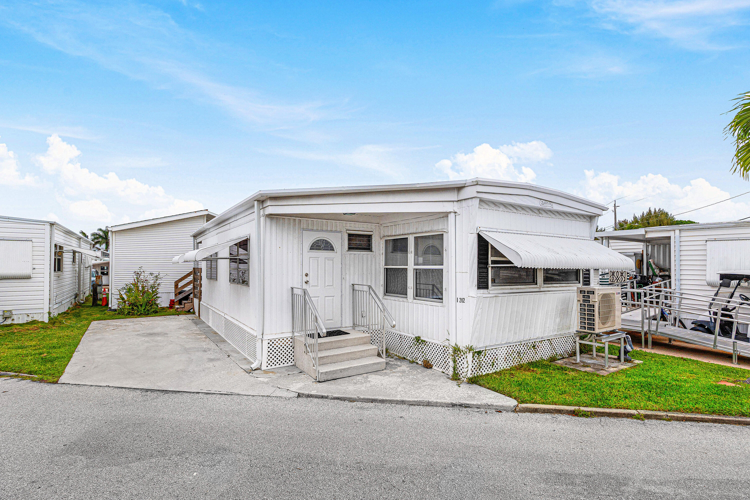 27 SHARES. Welcome to 202 Palm I Drive in Briny Breezes! This unique 1.5-wide unit offers an expanded layout that provides exceptional comfort and flow, setting it apart from typical homes in the community.  Inside, you'll find an updated kitchen designed for both style and functionality, along with the convenience of an in-unit washer and dryer. The generous living space is perfect for relaxing or hosting guests, while the seamless layout enhances the home's airy feel.  Step outside to a private back porch..an ideal setting for entertaining, enjoying the ocean breeze, or unwinding after a day in the sun. The property also includes a dedicated parking space for added ease.