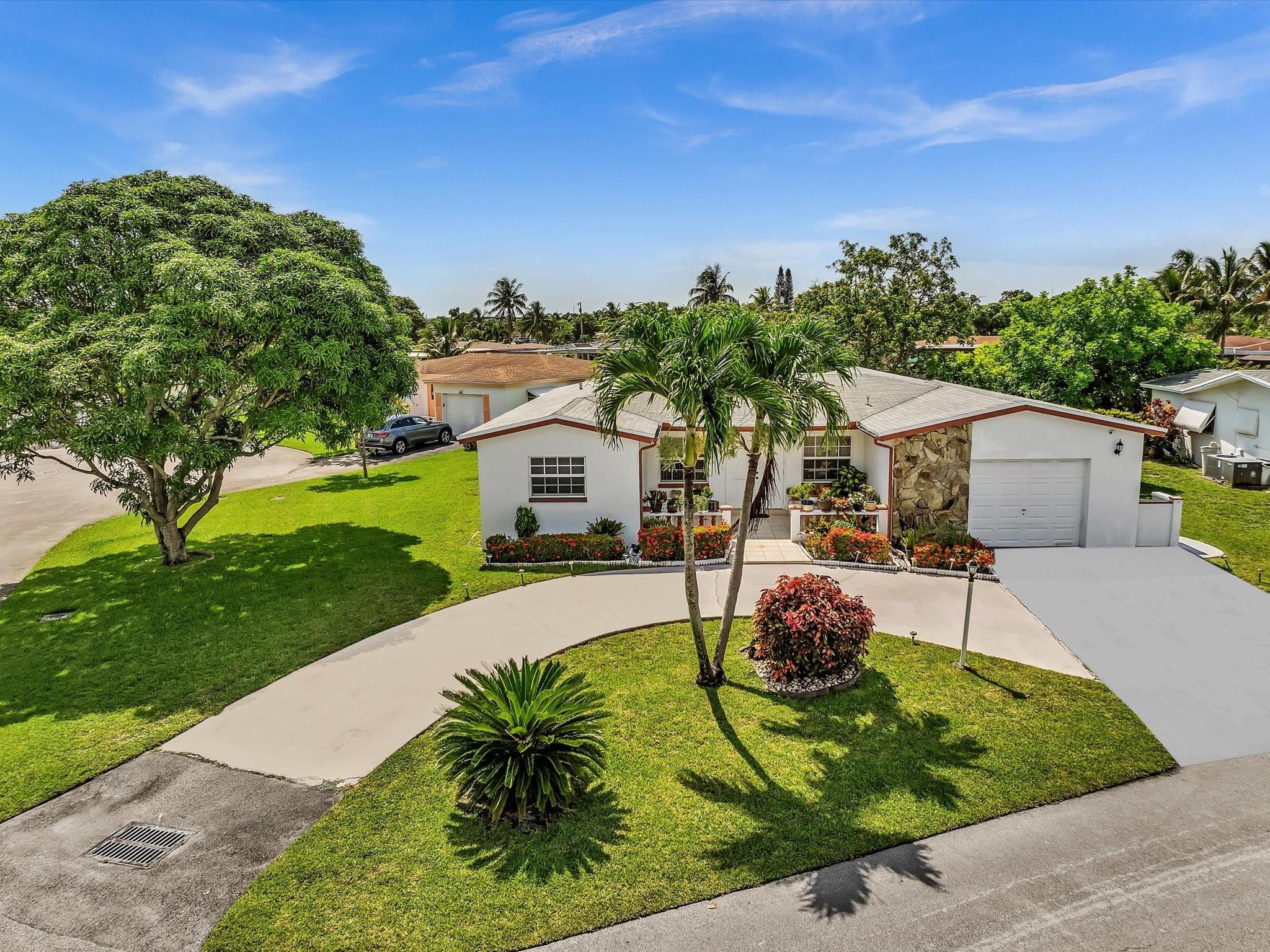 55+ COMMUNITY. ONLY 1 PERSON MUST BE 55 or older, other occupants must be 18 or older.  LOW TAXES & LOW MAINTENANCE FEE. ROOF 2018. HOA includes: lawn care, sprinkler system, & exterior painting. Step inside this well-maintained 3 bed/2 bath home & discover an open, airy floor plan designed for easy living and entertaining. Split floor plan offers privacy, formal dining & eat-in kitchen provides versatile spaces for meals & gatherings. Master suite features jacuzzi tub/shower & walk-in closet. Other upgrades: impact windows & doors. Oversized lot w/ circular driveway, this home boasts stunning, unobstructed water views w/mature fruit trees. A peaceful cul-de-sac location offers privacy & tranquility.