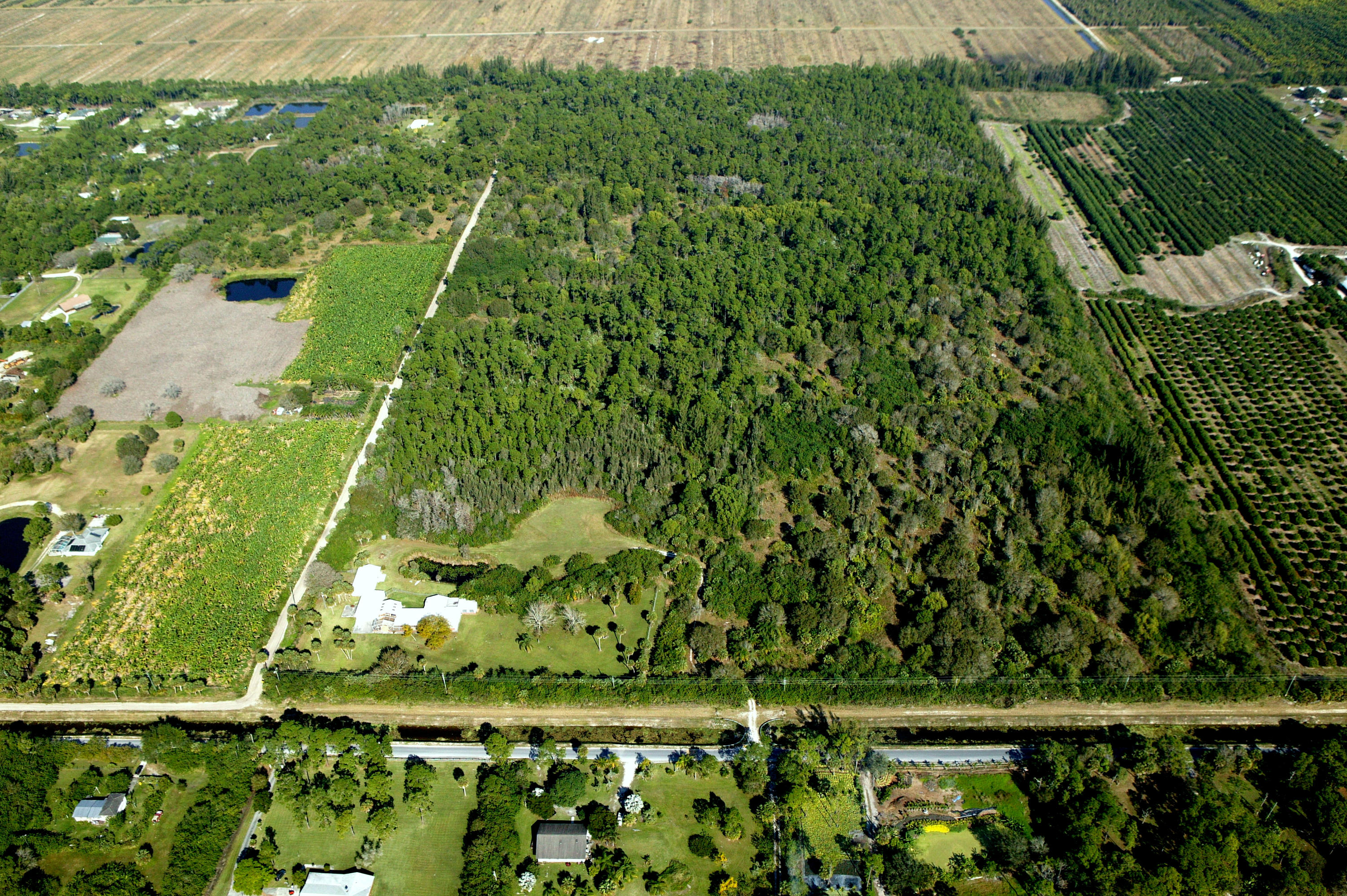 Fantastic business opportunity to develop or subdivide this 80 acre parcel. A quick 8 miles to the Winter Equestrian Festival, Global Dressage, and the International Polo Club. House situated on 5 improved acres with a pond. 75 remaining acres are unimproved and can be easily subdivided by buyer. Acreage total is 80 Acres. Land divided into 6 separate parcel control numbers.