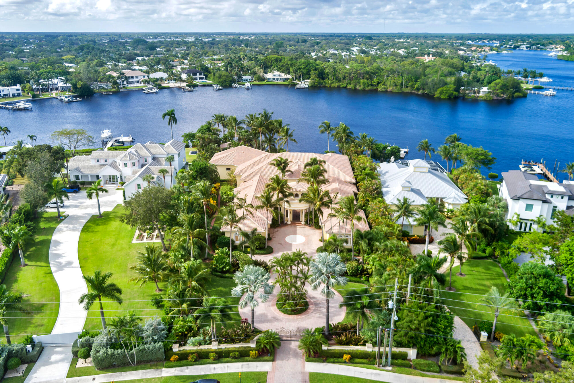 Hidden on the Loxahatchee River rests the most expansive, private waterfront estate in all of Tequesta. Boasting 130' of water frontage with pristine private westerly views of a protected river frontage in the distance. This glorious 17,000' single-story home is situated on a massive 52,000' lot. Featuring 5 spacious bedrooms, 5+ bathrooms, a 5 car garage (with a 6th A/C'd storage bay,) a sprawling resort-style covered patio with grotto-like swimming pool, a detached concrete block gazebo, a separate boathouse & a covered boat lift. The magic of this property is everywhere but it begins at the grand courtyard entry. With colossal iron/glass entry doors, the home was designed with entertaining and privacy in mind. The Loxahatchee River and pool are the perfect backdrop to every common area as well as the primary bedroom and office suites.
Close to amazing dining both by water or by car. This home is minutes to the Jupiter inlet, premier waterfront dining, shopping & in close proximity to top private & public schools, golf courses, country clubs and much more.