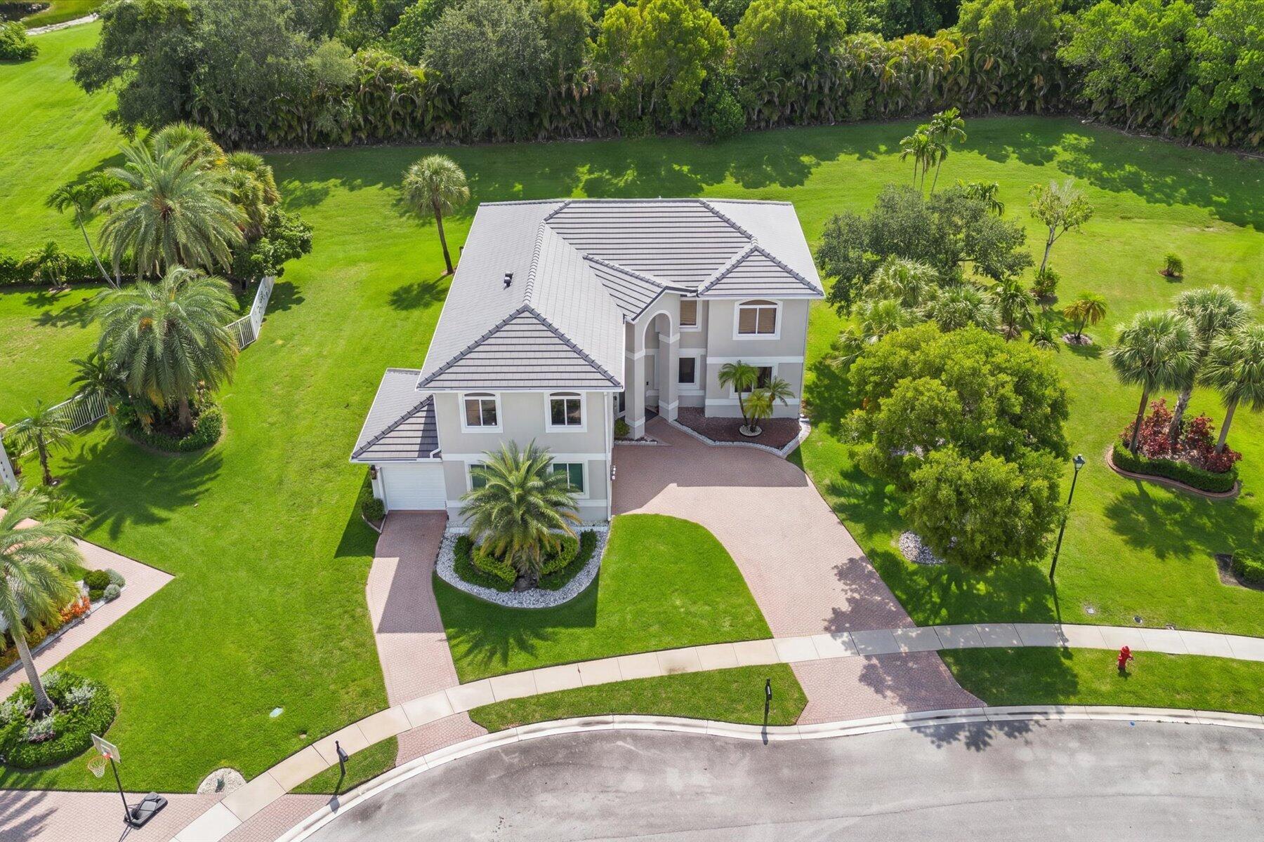 Located in the prestigious Regatta Bay neighborhood of The Isles at Wellington, this beautifully updated 6-bedroom, 4-bath home sits on a private 0.36-acre cul-de-sac lot. Recent upgrades include a new roof (2026), PGT hurricane-impact windows and doors, garage doors, quartz countertops, GE Profile appliances, new pool equipment, remote blackout shades, LED lighting, and a security camera system. The flexible floor plan features a first-floor guest suite and an upstairs theater/flex room ideal as a sixth bedroom, office, or gym. Professionally landscaped and move-in ready, this exceptional home is just minutes from Wellington International, home of the Winter Equestrian Festival, shopping, dining, and top-rated schools. New Roof (February 2026): Premium Polyglass roofing system featuring 1 layer of MTS Plus and 1 layer of TU Max underlayment, engineered for exceptional durability, weather resistance, and leak protection.   Professionally maintained landscaping with a ProTek irrigation and fertilization system enhances year-round curb appeal.   Ownership in The Isles at Wellington includes:  Hotwire Fision high-speed internet, cable, and HBO, ADT basic alarm monitoring.  A newly renovated clubhouse, two community pools, tennis courts, a full fitness center, and miles of scenic walking trails throughout the community.
