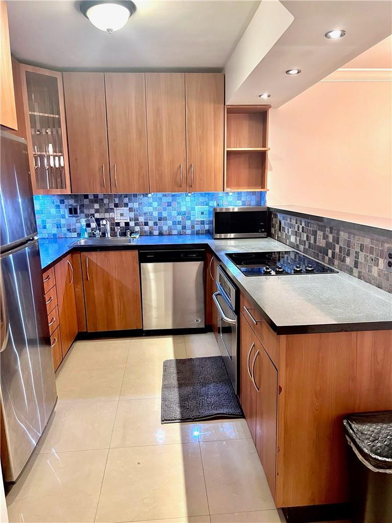 Beautiful and spacious 2-bedroom, 2-bath split-bedroom residence in the well-maintained Olympus condominium community. Bright 11th-floor unit featuring an open kitchen with stainless steel appliances, updated bathrooms, and beautiful Intracoastal and city views. Functional split-bedroom layout offers privacy, generous living space, and abundant natural light. Building recertification completed and current assessments for completed work paid by seller. Resort-style amenities include fitness center, heated pools, spa, sauna, tennis courts, BBQ area, marina, valet, and 24-hour security. Walking distance to the beach, shopping, and restaurants. Close to Gulfstream Park, Aventura Mall, airports, casinos, and the Hollywood Boardwalk.