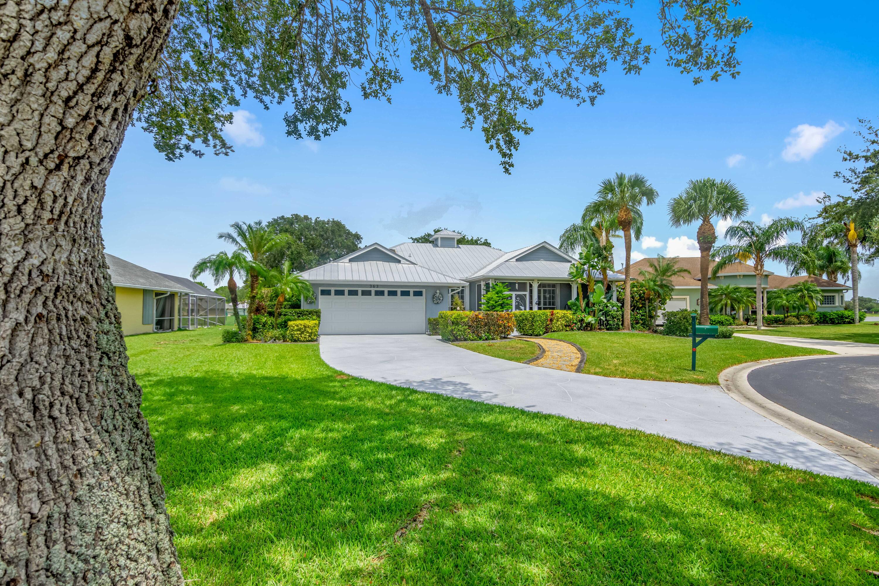 For sale for the first time, this custom built, lake front, pool home is ready for new owners. As you pull through the front gate and drive under the mature oak tree tunnel to a private cul-de-sac, you are greeted with gorgeous curb appeal. The extra long, newly coated, decorative, epoxy driveway with stone walkway has plenty of room for guests. The expansive Florida-Native landscaping with dark concrete edging, water fountain, and front screened porch gives off a resort feel. The double front doors offer a wide view of the open floor plan. Plantation shutters throughout allow plenty of light in. In the formal dinner area, a built in wet bar with sink and wine rack was added. The den is currently set up as an office with enough room for two desks. The living and breakfast areas overlook the pool and each have pocket sliders bringing the outdoors in when the weather is nice. The kitchen has been updated with refaced cabinets,  pantry slide-outs, newer stainless steel appliances, and added coffee bar. The guest rooms are tucked behind the kitchen and share the remodeled cabana bathroom with seamless glass, tiled, shower. The main suite offers a tray ceiling and sitting area with a wide view of the lake from the bay windows and pool access sliding doors. The main bathroom was redesigned and upgraded with an expansive shower with seamless glass, rain shower head, seats, and new vanities. The back patio is built for entertaining and enjoying the Florida weather. The custom built, aluminum awnings and cabana area with power keeps you comfortable no matter the time of day. The recently resurfaced, Louden built pool/spa has tons of seating and can either be solar or electrical heated. The fenced in yard and accordion shutters keep everyone safe. A gate to the lake allows fishing and boating access for electric powered boats. With major components like the roof & gutters replaced in 2018, A/C system and impact garage door in 2019, and tankless water heater in 2020, give piece of mind.