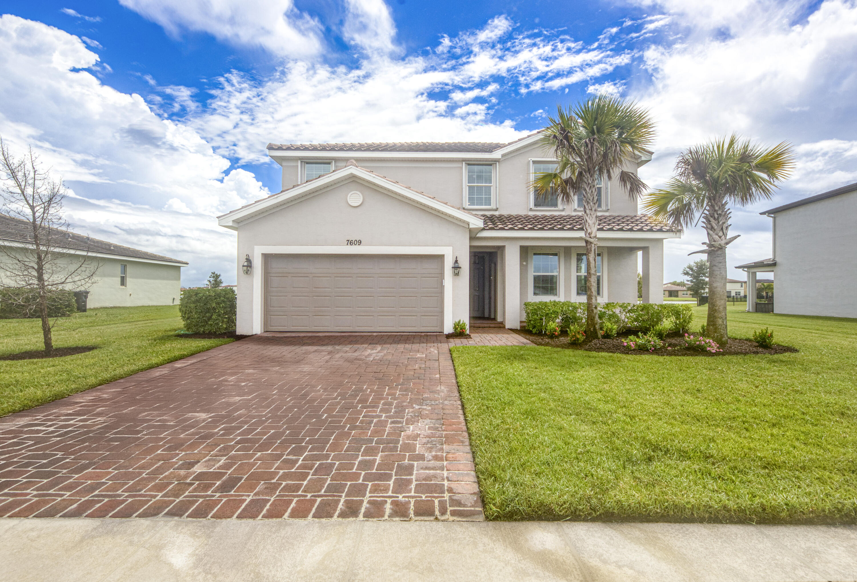 Gorgeous Sago model smart home on a .30-acre lakefront lot in the desirable, family-friendly Copper Creek community. This home features a private in-law quarters with living room, dining, kitchen, bedroom, full bath, and washer/dryer—perfect for guests or rental income. Enjoy peaceful lake views from the screened lanai, ideal for morning coffee or sunsets. Freshly painted with wood plank tile on the first floor and soaring 10 ft ceilings, the chef's kitchen with island seating opens to the great room for easy entertaining. The impressive owner's suite features an oversized walk-in closet and spacious ensuite bath. With large bedrooms, abundant storage, and a low monthly HOA with resort-style amenities, this home is perfect for any growing family.