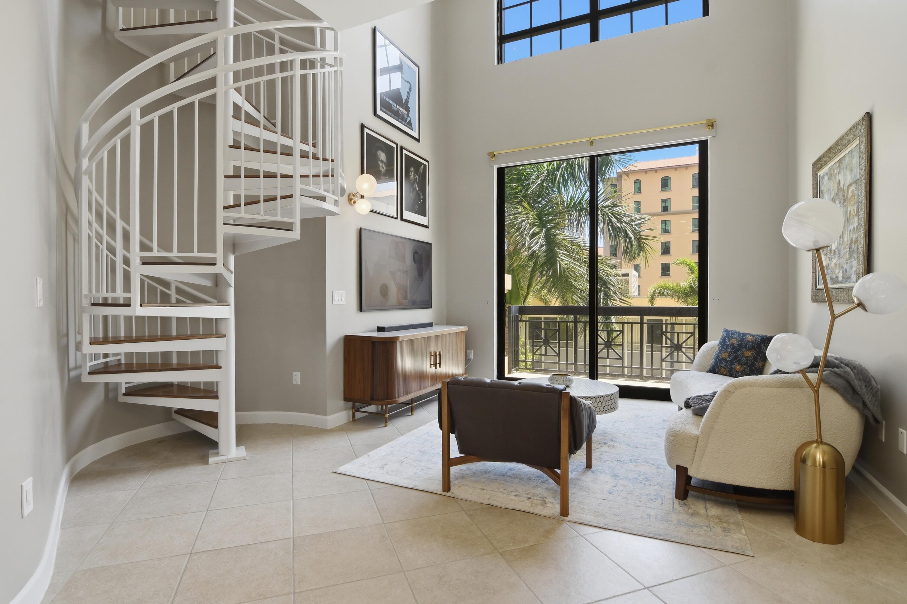 This impeccably maintained loft delivers the perfect blend of modern luxury, convenience and lifestyle with soaring 26' double height ceilings and expansive windows that flood the space with natural light. The residence features a sleek chef's kitchen with 42" white cabinetry, natural granite countertops, Café appliances and all new fixtures. The spacious primary suite offers two walk in closets, dual vanities, a garden tub and separate shower.  Set within one of the area's most desirable full service buildings, residents enjoy resort style amenities including 24 hour front desk service, complimentary valet, rooftop pool with panoramic city and ocean views, summer kitchen with grills, sauna and steam rooms, fitness center, club room and more.  Complete with 1 parking space and 1 storage unit, this move in ready residence is less than one mile to the beach and moments from top dining, cafés, nightlife and the growing business and tech hub transforming the area into one of the country's most exciting places to live and work.