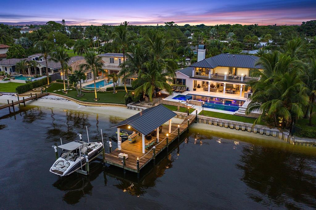 Extensive renovations in 2017 bring this stunning south facing Loxahatchee River home to like new status! The transitional styled front elevation and paver drive welcome you. Items of significance include all new wiring with new panels, Control 4 system, 3 ac units and ductwork. The 500 gallon propane tank fuels the range & Salamander broiler,  whole house insta-hot water, master bath steam shower, dryer,  pool heater, tiki torches, fire pits, summer kitchen grill, and Generac generator. The chef's kitchen is complete w double ovens and induction cooktop.  Ground floor master suite, 3 en suite guest rooms on the upper level.   Everyone will enjoy the living and a spacious outdoor terrace with sweeping river views. New sea wall and infinity edge pool with elevated spa. Lush tropical landscaping with custom lighting, gas tiki torches and fire pits.  Speakers inside and out, beautifully equipped summer kitchen, pecky cypress ceiling and marble pool pavers. Gorgeous dock with 25,000 pound extra wide lift, water and electric. Complete impact windows and doors for storm protection.