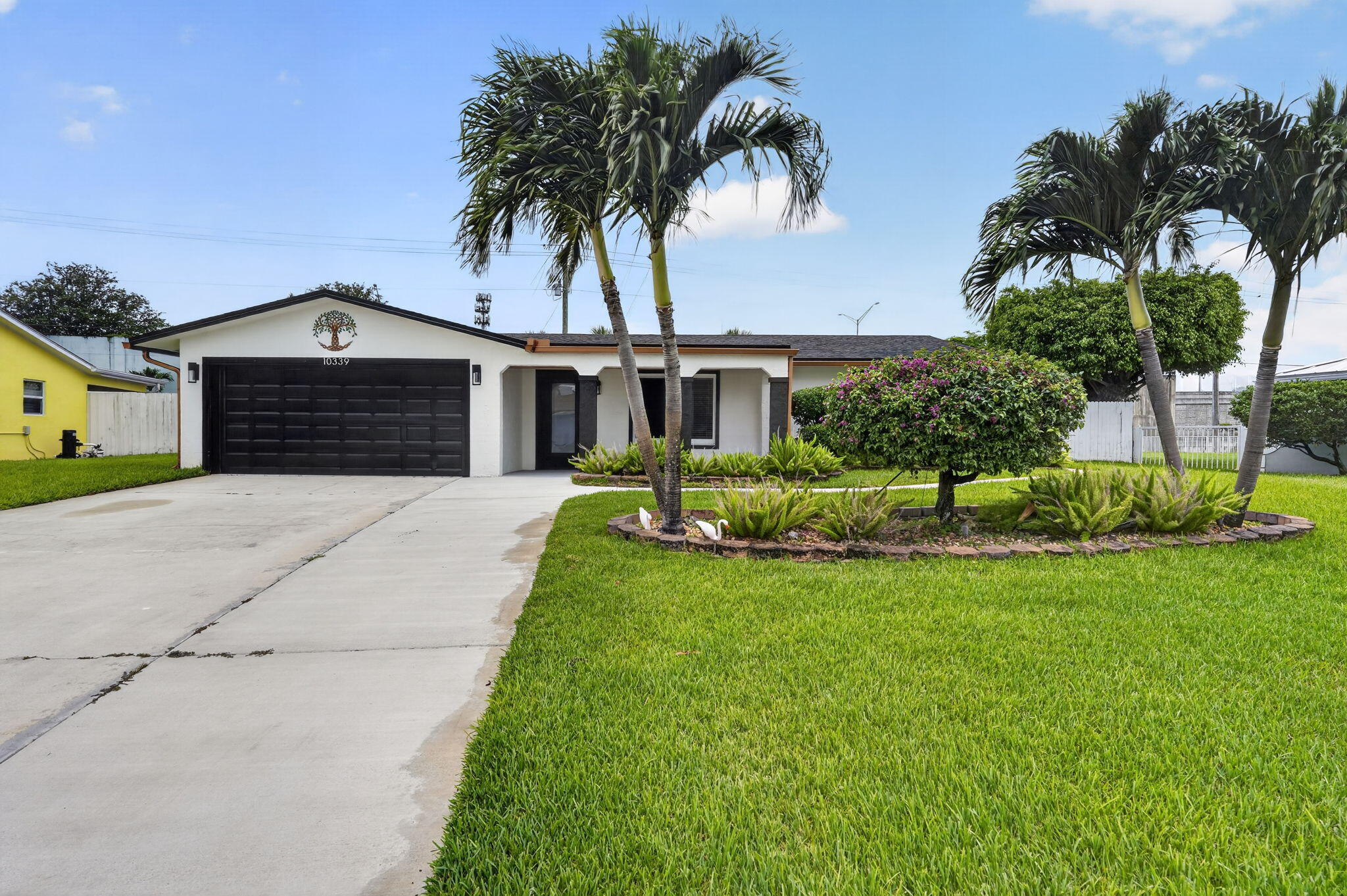 Welcome to one of the most unique properties on the market! With NO HOA, three separate structures, and countless possibilities, this fully upgraded South Florida retreat is designed for the way people want to live today. The main home offers 3 bedrooms, 2 bathrooms, multiple living areas, formal dining, and an A/C-equipped 2-car garage, totaling approximately 2,000 sq. ft. under air. Features include impact windows and sliders, spray-foam attic insulation, stunning polished tile flooring throughout, and fresh interior and exterior paint completed in 2025. Step outside to your private backyard oasis featuring a screened patio, sparkling pool, and beautifully maintained grounds. Need extra space? Enjoy a detached A/C flex building perfect for a home office, gym, studio, or game room, plus a