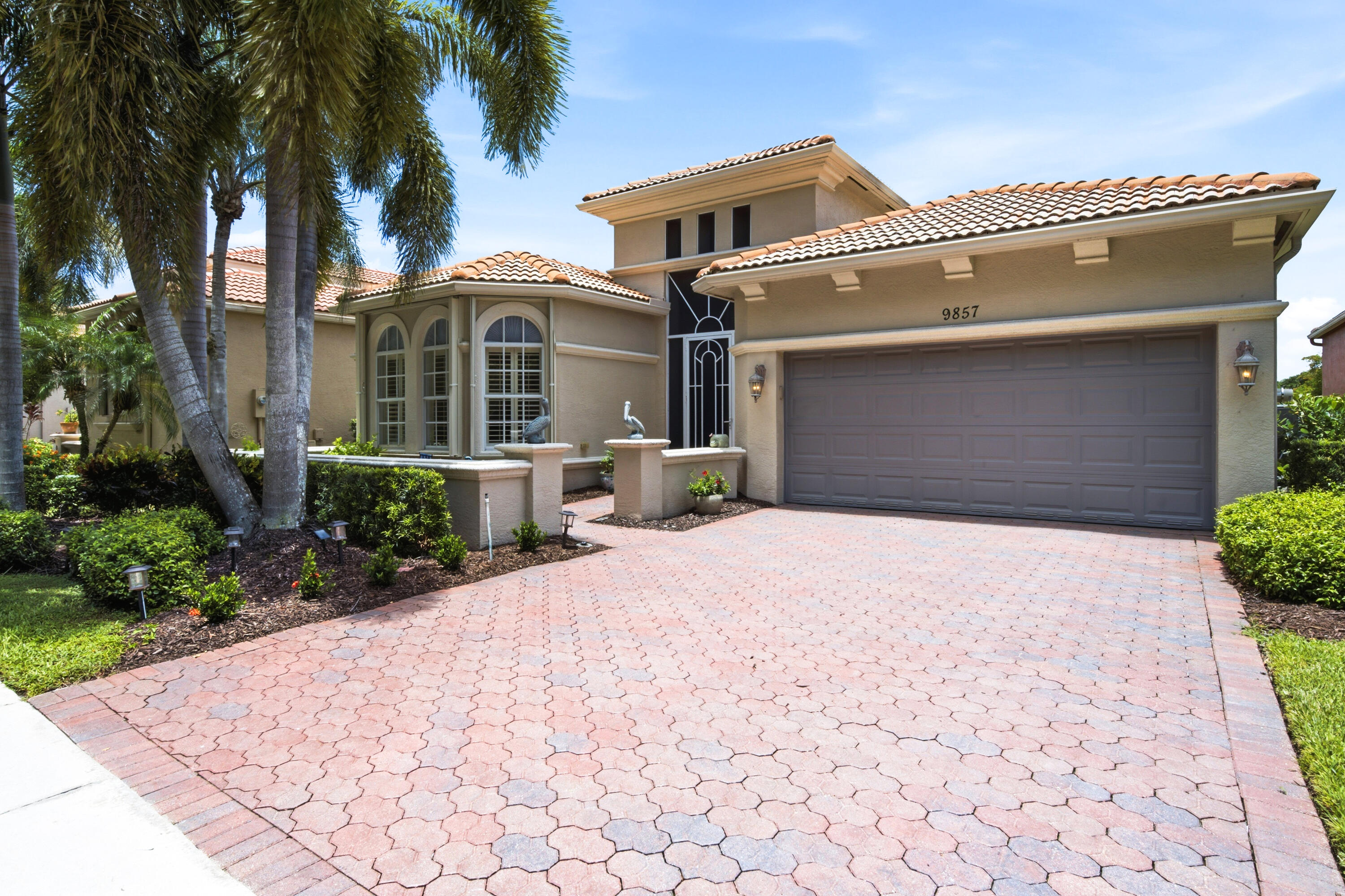 Nestled in the highly sought-after 55+ community of Buena Vida, this elegant Mediterranean-style home offers a spacious split floor plan with 2 bedrooms, 2.5 bathrooms, plus a versatile office with custom built-ins that can easily be converted into a 3rd bedroom. Enjoy a chef's kitchen with granite countertops, newer appliances, and an open-concept layout perfect for entertaining. Major updates include a 2023 A/C, 2022 water heater, 2023 refrigerator, 2024 flooring in three bedrooms, 2021 washer and dryer, 2022 kitchen faucet, 2024 light fixtures, 2023 baseboards, 2022 garage storage with attic stairs, accordion shutters, and recent roof cleaning/treatment (2024 & 2026). Relax on the extended screened patio with peaceful canal, lake, and preserve views. Over $69,000 has been invested in  upgrades and improvements.  Buena Vida is one of Wellington's premier active adult communities, offering a 24-hour manned gate, resort-style clubhouse, fitness center, pool and spa, tennis, pickleball, café, billiards, library, ballroom, steam rooms, arts and crafts, and a vibrant calendar of social activities. Ideally located just minutes from Wellington's world-renowned equestrian venues, The Mall at Wellington Green, fine dining, Florida's Turnpike, I-95, downtown West Palm Beach, beautiful beaches, and three international airports, this exceptional home delivers the luxury, convenience, and resort-style lifestyle buyers are searching for.