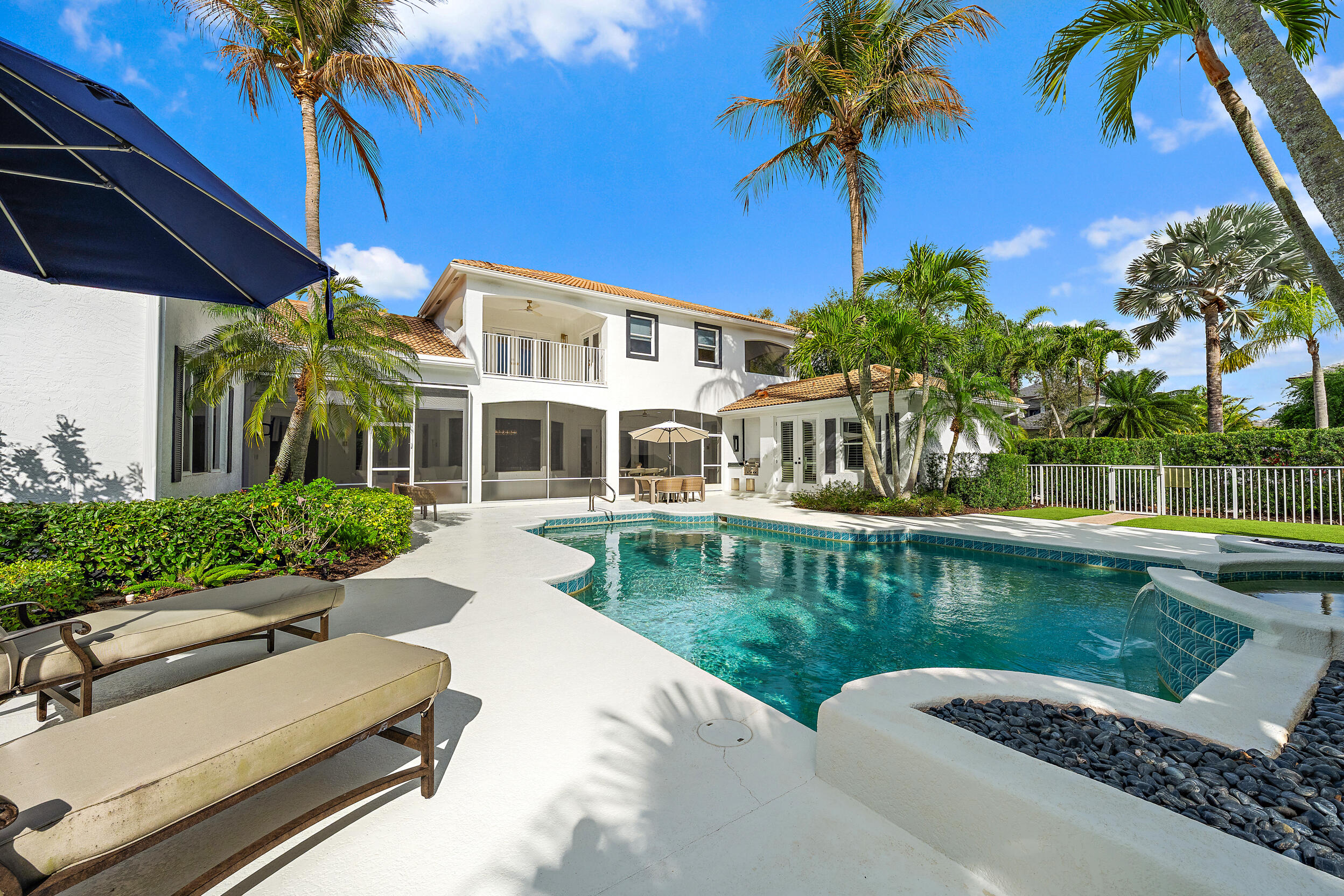Located on a large lot on the east side of Admirals Cove, this home offers a rare combination of space, privacy, and a full golf membership. Tasteful updates have been made throughout, and the first-floor primary suite provides comfort and convenience with easy access to the main living areas. The oversized lot provides generous outdoor space with a large pool and expansive backyard ideal for relaxing or entertaining. A detached guest house offers private accommodations for visitors, making this property particularly unique. The spacious outdoor areas provide plenty of room to enjoy the Florida sunshine, host gatherings by the pool, or unwind in a private backyard setting. Admirals Cove is one of Jupiter's most sought-after private communities, offering 45 holes of championship golf, two clubhouses, two driving ranges, a world-class marina with direct ocean access, a state-of-the-art fitness center, tennis and pickleball courts, multiple dining venues, and a full calendar of social and recreational activities.