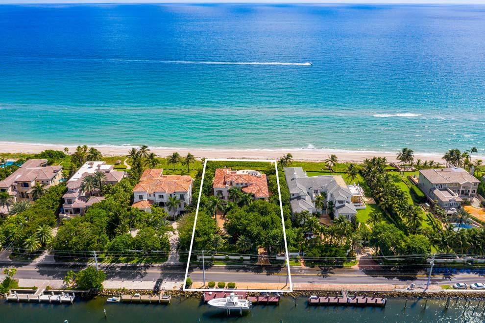 Welcome to 1009 Hillsboro Mile, an incredible direct Ocean-to-Intracoastal estate in one of the country's most exclusive and sought after stretches of oceanfront property. Hillsboro Mile features incredible oceanfront properties offering not only the opportunity to live directly on the ocean but also own the Intracoastal for the best of both worlds and a South Florida lifestyle second-to-none. Meticulously maintained with over 15,000 total square feet the property has it all. Impact doors and windows; breathtaking ocean views; 14-seat movie theater; main floor office; pub-style lounge and bar room; roof top entertainment area, club room and terrace with summer kitchen; large master wing with covered balcony; infinity edge pool; gourmet kitchen; and 100' dock with boat and jet ski lifts. Features Include: 
*110 Feet of Direct Ocean and Direct Intracoastal Waterfrontage 
*Private Beach Access 
*Private Dock with 24,000 Pound Neptune Boat Lift and Jet Ski Lifts 
*Five Bedrooms Plus Multi-Purpose Room and Office / Seven Full and Two Half Bathrooms 
*9,207 AC Square Feet / 15,319 Total Square Feet  
*Gated Compound with Decorative Drive 
*Grand Entry with Waterfall Feature 
*Elegant Foyer and Formal Living Room and Gorgeous Ocean Views 
*Volume and Tray Ceiling, Custom Finishes, and Marble and Hardwood Floors 
*Gourmet Kitchen with Top-of-the-Line Appliances and Dining Area 
*Formal Dining Room with Custom Wine Room 
*Family Room with Access to Covered Loggia, Summer Kitchen and Pool 
*Paneled Club Room with Full Bar 
*14-Seat Home Theater with Bar 
*Main Floor Paneled Office with Balcony 
*Spacious and Private Master Wing with Sitting Area, Balcony, Closets and Master Bath 
*Four Additional En Suite Guest Bedrooms 
*Multi-Purpose Room Serves as Gym, Workshop or Bedroom 
*Roof Top Terrace with Hot Tub, Outdoor Shower, Summer Kitchen and Dining and Lounging Area 
*Roof Top Interior Bar with Entertainment Space 
*Full Laundry Room with Additional Laundry Closet 
*Five Bay Air Conditioned Sports Garage with Storage 
*Landscaped Grounds with Pathways, Front Yard with Putting Green and Private Dune to Beach 
*11-Zone A/C System 
*Full-House Generator and Impact Glass Windows and Doors