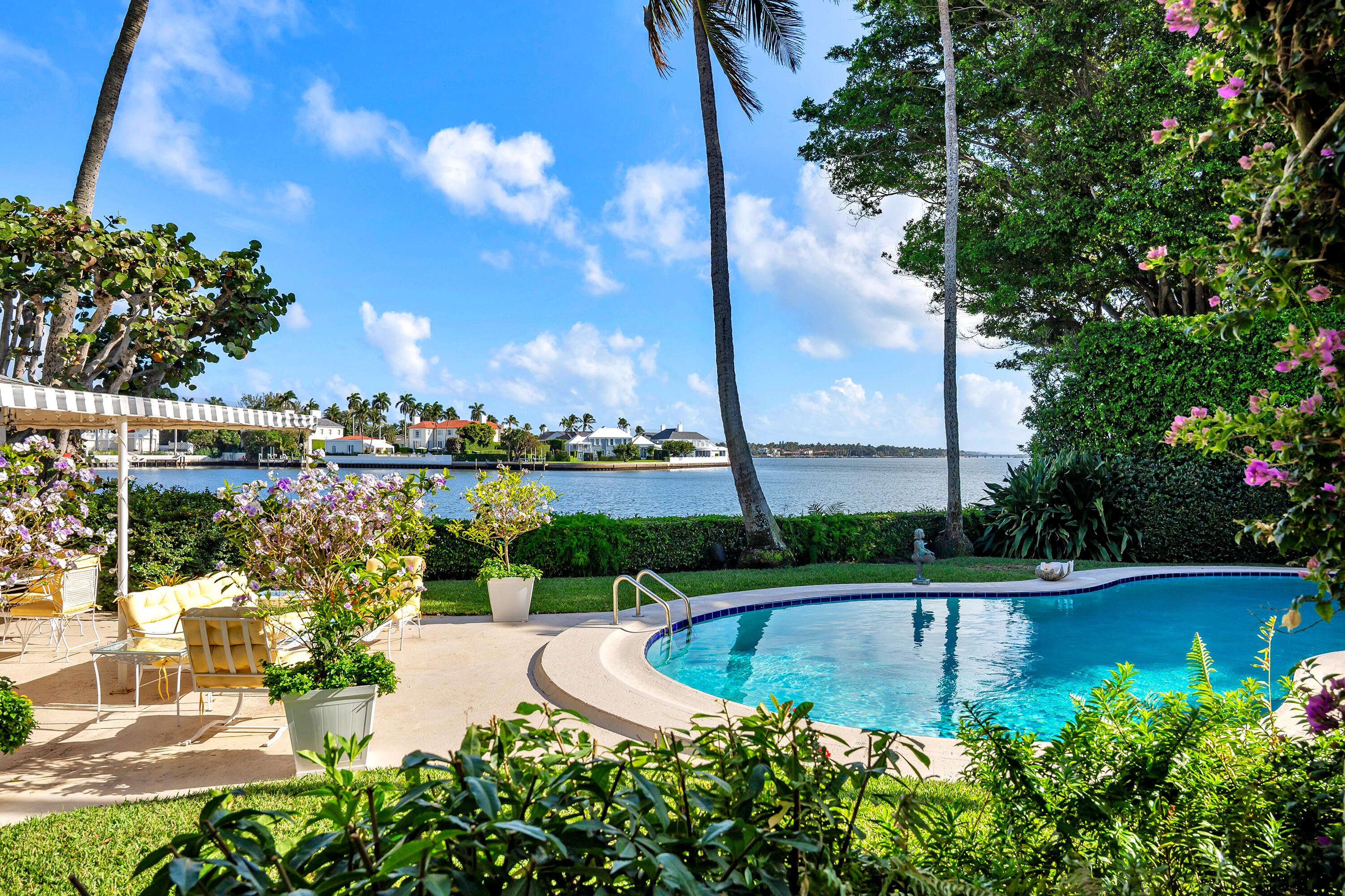 Located on Island Road in the Estate Section of Palm Beach, this 33,301± square foot property offers 107± feet of direct Intracoastal frontage. The property is particularly unique for its rare water views to the south and Everglades Club golf course views to the north. The lot's size, frontage, and premier location present an exceptional opportunity to build a new waterfront estate in one of Palm Beach's most desirable residential areas.  The property currently features a 6,729+/- total square foot Mid-Century residence. The main house includes six bedrooms, six full bathrooms, and one half bath, along with formal living and dining rooms, a kitchen with butler's pantry, and a large party room with bar and kitchenette designed for entertaining.  A separate pool house includes an additional two bedrooms and two full bathrooms.  The grounds have a waterfront pool, as well as a spacious yard with a pond and orchid slat house.  Additional features include a two-car attached garage, carport, full house generator, and full house water filtration system.