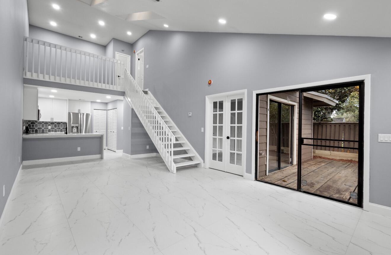 Beautifully professionally remodeled designer townhome offering 3 bedrooms plus loft in a tranquil waterfront setting! This gorgeous corner unit overlooks a peaceful pond with fountain views in a quiet, well-maintained community with low HOA fees. Since this is an HOA and not a condo, all financing types are welcome! Features include soaring vaulted ceilings, custom shaker cabinetry, quartz waterfall countertops, stainless steel appliances, and stunning updated baths. Two bedrooms and shared bath downstairs, with luxurious upstairs primary suite plus loft. Spa-like primary bath features double vanities, soaking tub, atrium windows, and large walk-in closet. Shows like a brand-new model home!