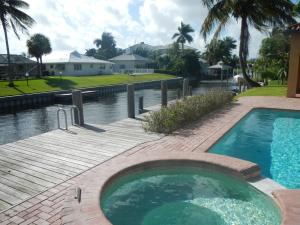 Remarkable waterfront pool home with 100 ft of frontage on canal leading to Lake Eden and Lake Ida. Phenomenal square footage for the area in a newer home, 5BR/4.5BA including a separate office and game room. Spacious downstairs master bedroom withcoffered ceiling, walk in closet and renovated master bath. Upstairs includes a loft, ideal as secondary entertainment area as well as 4BR's, two renovated bathrooms and full size laundry closet. Kitchen features granite counters, newer ss appliances and oversized pantry. Backyard is ideal for outdoor living with covered patio, resurfaced pool, pavered deck area and custom built dockage. Interior courtyard include lush landscaping and soothing water feature. Finally, an oversized 2 car garage featuring loads of storage. Please note guest house sq