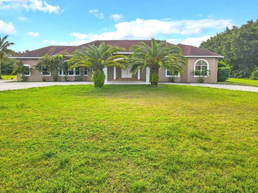 Beautiful custom built estate allows you to entertain with style. Living room graced 20' ceilings, hurricane windows and 4 bedrooms plus 2 additional rooms set up as bedrooms. Many options can come into play for the split floor plan. Primary bedroom offers ample room with two separate walk in closets. sitting on 5 acres offers nature and total privacy. Circular Driveway brings an overflow of parking. This private property is located minutes from Palm Beach Equestrian Center , Wellington Mall and Lion Country Safari.  Background check & credit report with first, last and security deposit to accompany lease.