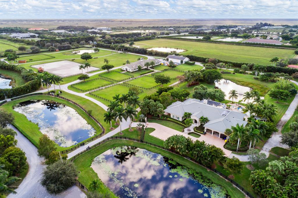 Newer construction and well laid out, this 20 acre property is ready for your finishing touches. Manor house with private entrance and 3 car garage. The barn features 8 stalls and is designed for a total of 16 stalls. An oversized 3 bay storage building easily accommodates a STX Van, RV and boat with room to spare. The all-weather ring, 6 large paddocks, and a riding track around the facility make this property an equestrian's dream property. Adjoining 10-acre farm also available for purchase MLS#: RX-10852413.