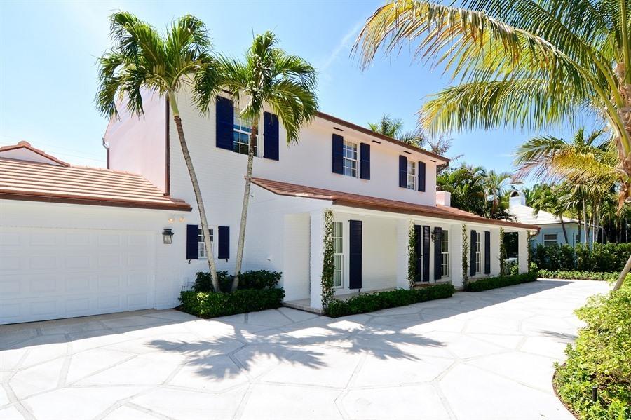 This elegant Palm Beach home is nestled on a private cul-de-sac on the North End. Beautiful south facing exposure and sunny pool area.  A newly renovated kitchen with best in class appliances presiding over a sunny breakfast nook, segues to a stately dining room opening to the outside entertaining area. Features include first floor master suite with his and her bathrooms, formal living room with fireplace, hardwood floors, office, guest bedroom on the first floor and an additional 2 bedrooms upstairs. This home is complete with meticulously manicured grounds and Lake Trail access.