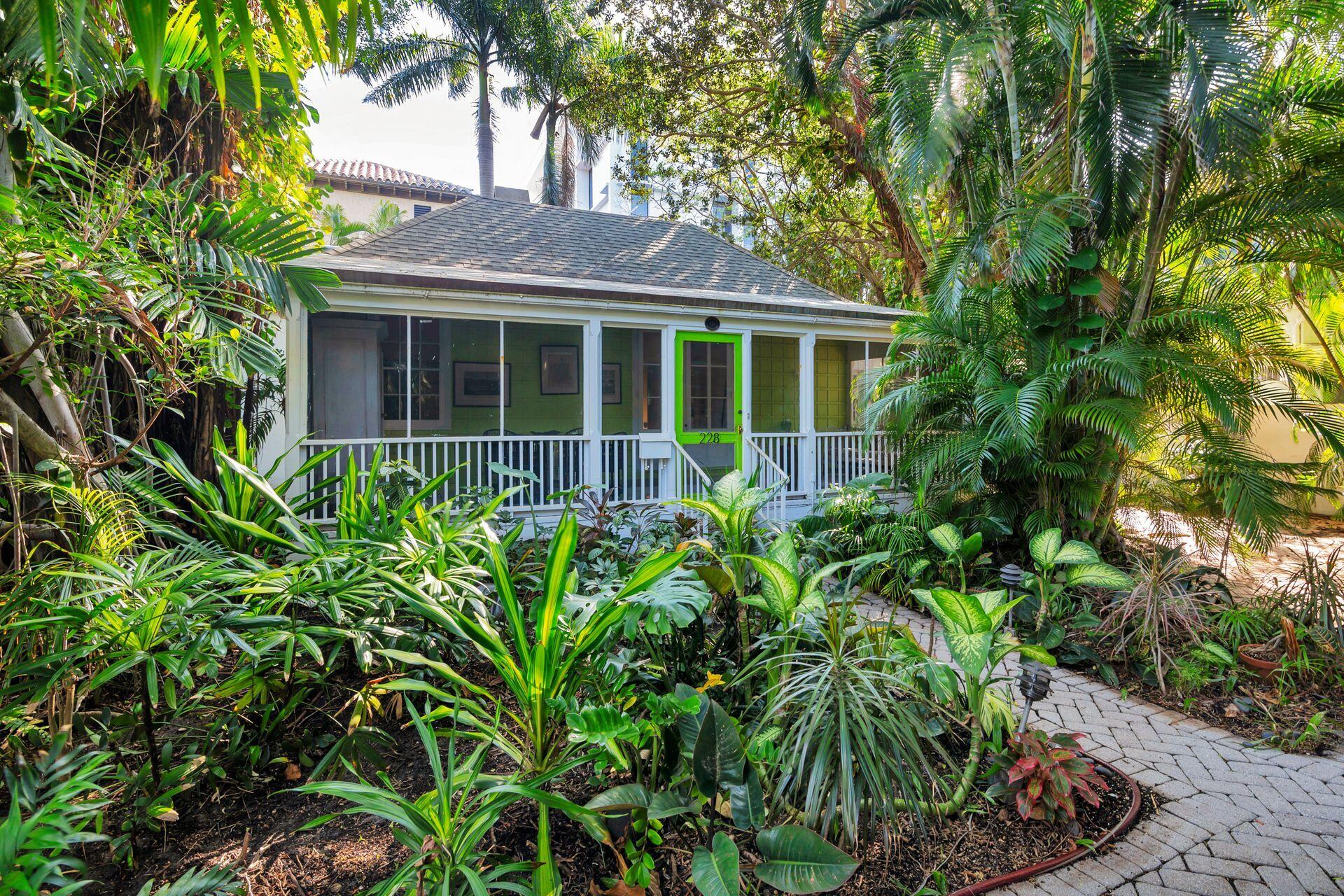 Walk back through time as you approach architect Howard Major's personal cottage nestled in historic Phipps Plaza, one block from the Ocean in midtown Palm Beach.  Built in 1941 by the renowned architect and landmarked, the classic Florida-style cottage sits in a secluded setting in the Phipps Plaza cul-de-sac, surrounded by lush greenery.  Included in the purchase is an adjoining landscaped lot which has the potential for a pool or water feature.