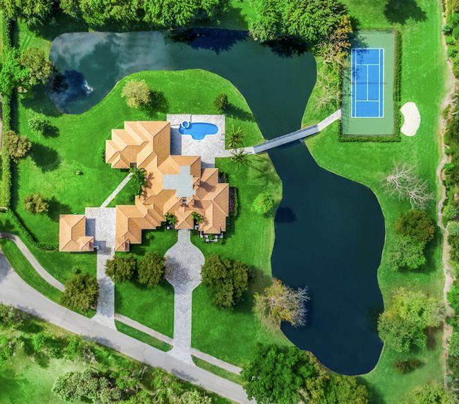 YOUR OWN PRIVATE OASIS! Situated in Boca Raton's ultra-private gated community of Le Lac, ranked by Forbes as one of the Top 10 Gated Neighborhoods in the U.S. The community encompasses 200 acres with only 32 homes. Surrounded by more than 60 acres of interconnected and independent lakes. The entrance to Le Lac is hidden from the main street, which adds to its sense of exclusivity and privacy.  This rare property sits on 4.73 acres, boasts its own private lake, tennis court, putting green, pool & more. 6009 is truly an incredible home & property that the owners meticulously recently did a $1,000,000 renovation to. New roof, new driveway, new flooring, new kitchen, new appliances, new bathrooms done to perfection! If privacy, acreage and luxury are top priority, this home is for you!