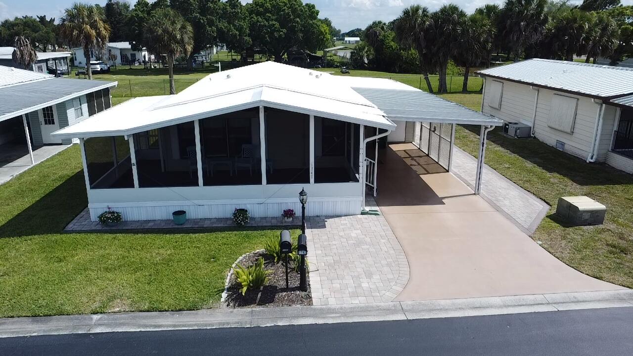 Enjoy the Florida lifestyle in this charming 2BR/2BA home nestled in a vibrant 55+ community! Start your mornings on the oversized screened front porch and entertain guests in a beautifully updated kitchen featuring granite countertops and a functional island. This active community offers a pool, clubhouse, and shuffleboard, along with social events and activities year-round. A perfect blend of comfort, convenience, and community living. Move-in ready and a must-see!