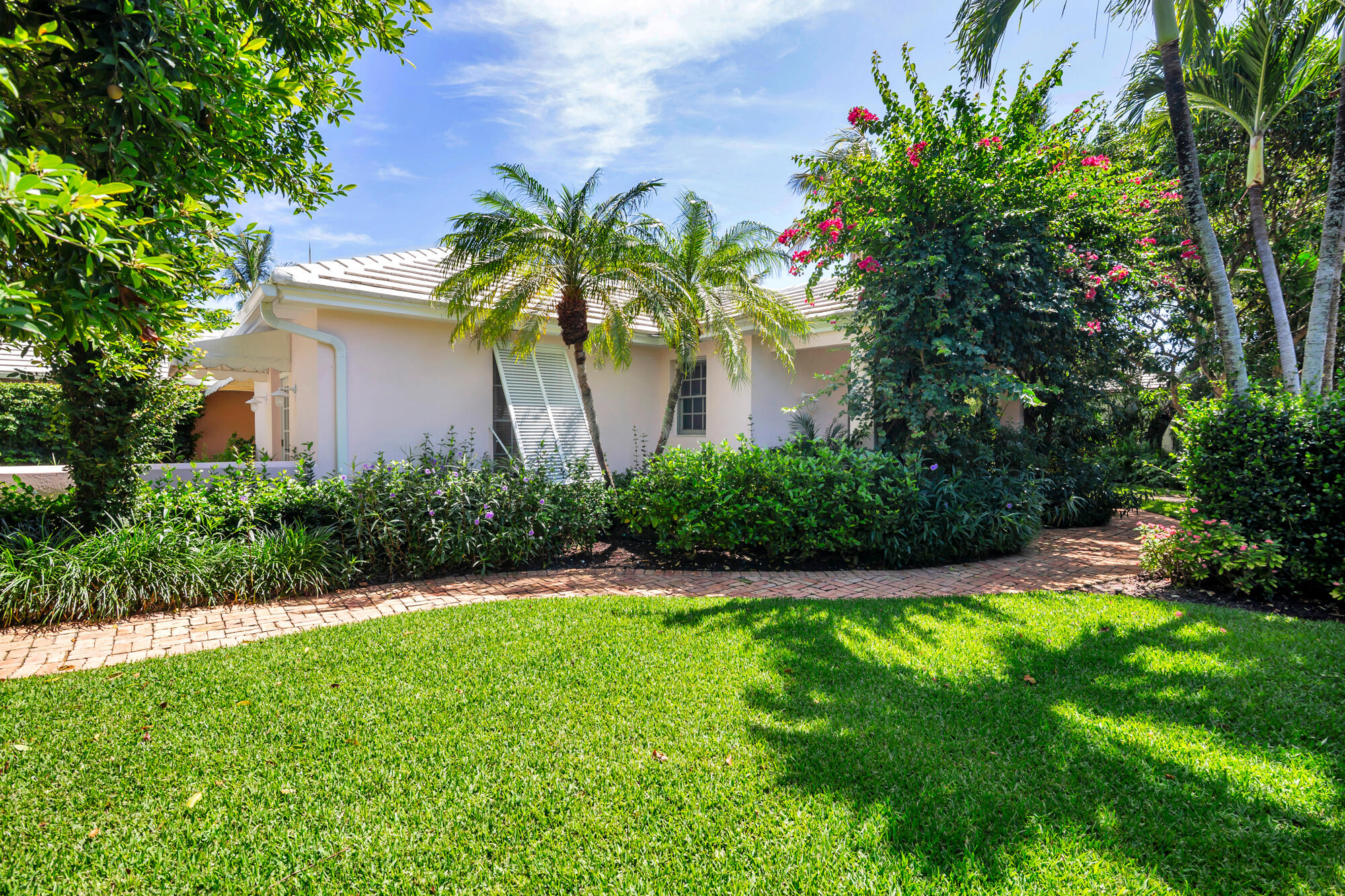 Wonderful Palm Beach cottage on a 14,029 SF lot on Garden Road, one of the most coveted streets on the north end.  The house, owned by an artist, has been a 4 Bedroom/4 bath winter retreat for herself and her family.   This tranquil oasis features lush tropical gardens surrounding a lap pool and a Jacuzzi.  Steeped in European history and 1930's and 1940's rattan décor, the home has a wonderful history of dining al fresco for casual, relaxed lunches and dinners.   Garden Road has Lake Trail access on the west end of the street and shared deeded and coded beach access at the east end of Eden Road. It also features a 2-car air-conditioned rear garage with a 4-car driveway off the Laurian Lane privacy road.   Whether you long for the simplicity and relaxed comfort of a Palm Beach cottage or wish to build your approximately 5,200 Sf dream house, this opportunity shouldn't be missed.