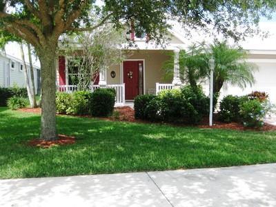 Welcome to desirable River Place on The St. Lucie! This spacious, Key West-style 4-bedroom, 3-bathroom home invites you to sit a spell on the front porch and enjoy the tropical breezes. Inside, a large foyer opens to formal living and family rooms boasting expansive lake views. The entertainer's kitchen features a breakfast nook, breakfast bar, stainless steel appliances, granite countertops, and 42'' cabinets. The thoughtfully designed layout includes tiled flooring throughout, with cozy Berber carpet and wood laminate in the bedrooms. Step outside to a large, extended screened porch and stamped concrete deck featuring accordion shutters and serene water views. Living here gives you access to incredible community amenities, including a clubhouse, pool, spa, fitness center, nature trails,
