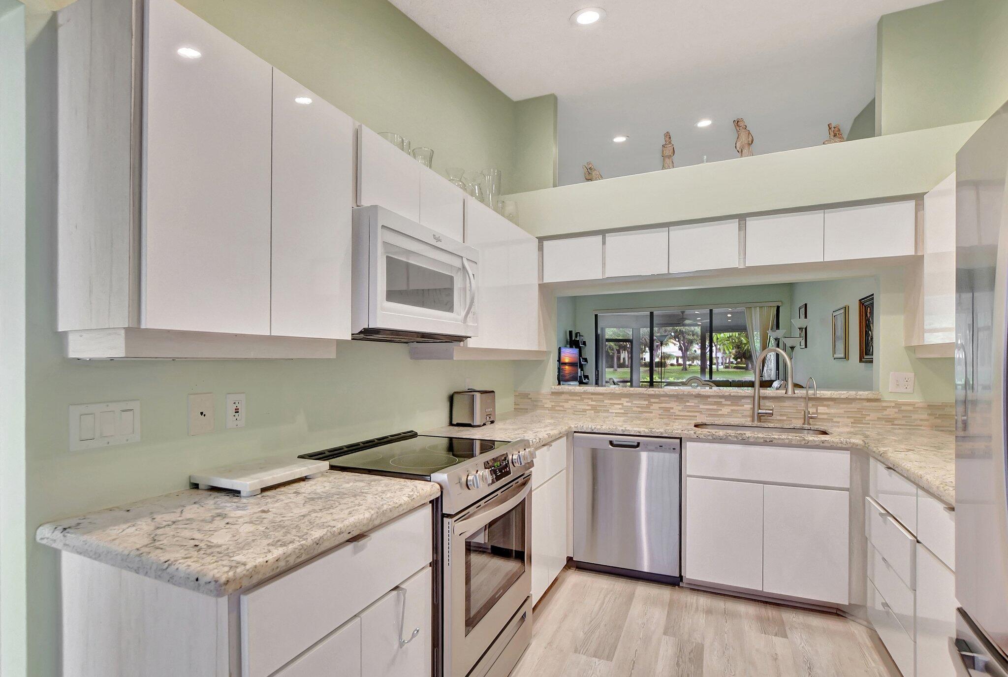 Boca Delray Golf and Country Club is a 55+ community with NO mandatory golf membership. Remodeled 2 bedrooms, 2 bathrooms, lake view villa that feels like a single-family home. NEW roof and gutters installed in summer 2024. Eat-in kitchen with new appliances, granite countertops, and sliding doors to the private courtyard. In-suite master bedroom, 2 walk-in closets, and sliding doors to the patio. Master bathroom has double sinks, separate shower and bathtub. Partial hurricane windows, lots of storage, 1.5 car garage. Many social activities at the renovated club, 24/7 manned security gate, 2 heated pools, 4 clay tennis courts, 2 pickleball courts, gym, library. The HOA includes cable, building insurance, exterior painting, cold water, reserve funds, roof maintenance, security, trash.