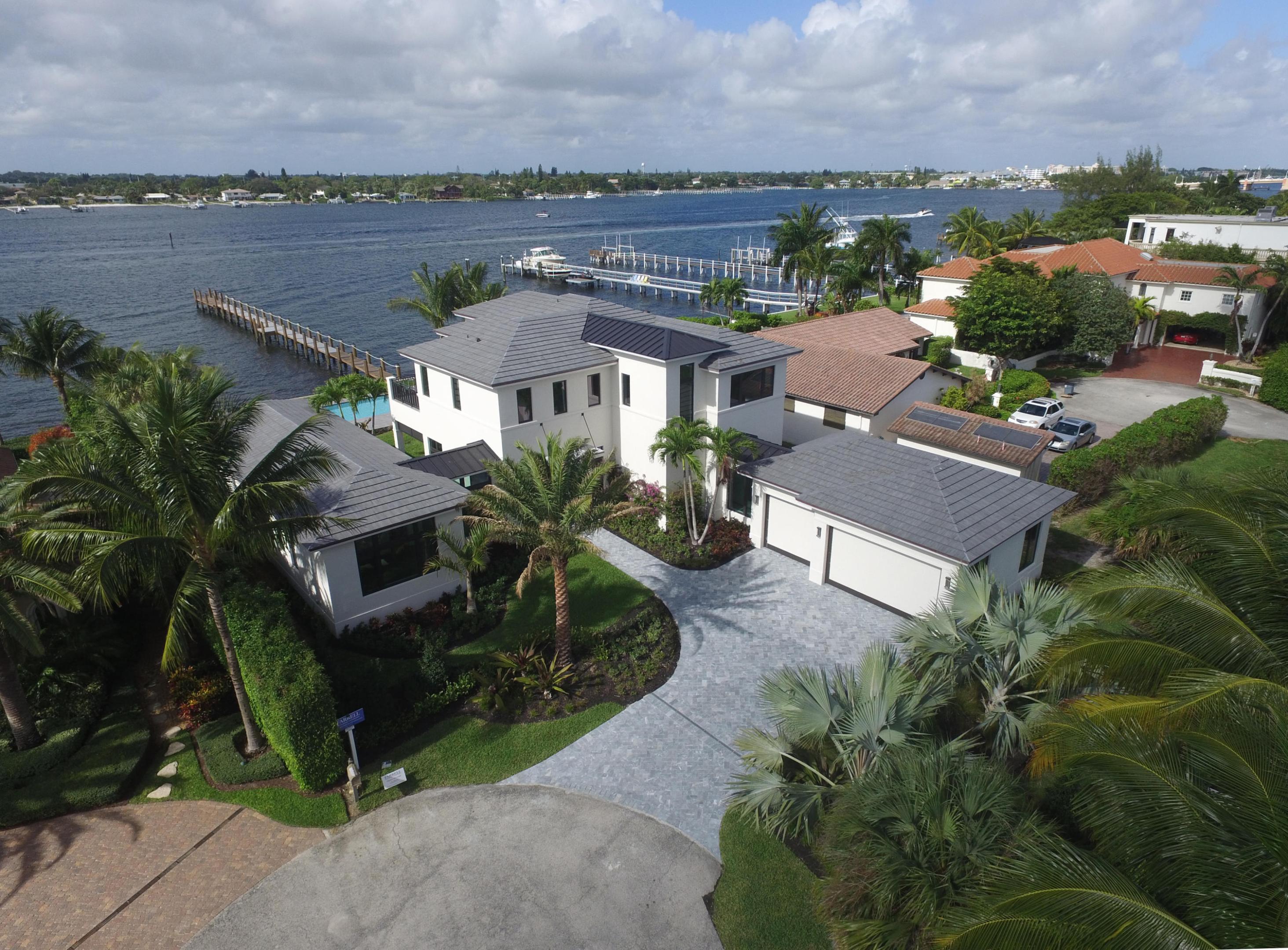 Just completed! New construction! This Hypoluxo Island home is located on a private cul-de- sac, Intracoastal lot with incredible water views. Joseph Farrell, the most sought after home builder in the Hamptons, has just completed this five bedroom, 5.1 bath beauty. The estate features a grand two-story foyer, large spacious rooms, a state-of-the-art gourmet kitchen, and a downstairs master suite. Extraordinary finishes and oversized impact glass windows add to the value of this home. Outdoor highlights include a large outdoor area with summer kitchen and heated pool, plus boat dockage for a large boat within minutes of Ocean access. Hypoluxo Island is an exclusive community nestled in the heart of Palm Beach County, just North of Delray Beach and a short drive to Palm Beach.
