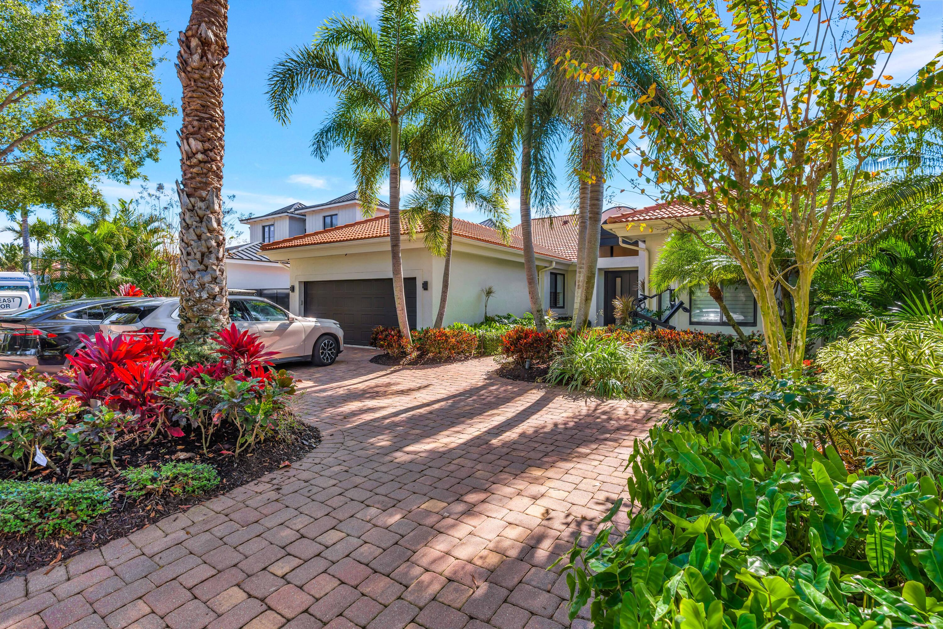 Exceptional privacy meets waterfront living!  Tucked away in a serene setting, this beautifully renovated 3 bedroom 3 bath residence with office offers the ultimate backyard oasis and effortless coastal living. The remodeled open kitchen offers beauty and functionality with new appliances, a coffee bar and cozy breakfast area. Enjoy peace of mind with impact windows, a full-house generator, tankless water heater, fireplace and thoughtful upgrades throughout. The 2-car garage is fully air-conditioned. Step outside to your private retreat featuring a beach-entry pool, hot tub, and screened lanai with Phantom screens perfect for year-round enjoyment. The property boasts a dock with ocean access, accommodating up to a 40' boat, complete with a 3-year-old 20,000-lb lift. This is turnkey... waterfront living with privacy, style, and functionality ready to enjoy from day one. The view is of greenery across the canal, no homes in sight. Sports membership offers golf 4X per mo in season and unlimited golf May 1 to Oct 31. Or you may apply for golf membership.   Enjoy all the first class amenities of Admirals Cove including two spectacular clubhouses, 45 holes of golf, 5 restaurants, 58 slip marina with floating docks, Yacht Club, 9 har tru tennis courts, 12 pickleball courts, state of the art fitness and wellness center with Technogym machines, 21,000 sq ft spa & salon, 30 room Waterside Private Boutique Hotel for members and their guests, brand new Golf Learning Center, Covesters kids club, dog park and Platinum service.