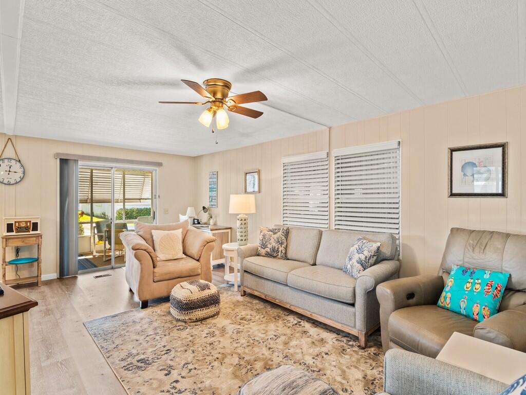 Enjoy easy living in Natalie Estates, a 55+ community in Stuart. This 2-bed, 2-bath home features new flooring, a 2021 AC, spacious layout, and screened lanai and it comes with this a 2007 Toyota Avalon that rides like a champ.  Home Includes wide, accessible doorways ideal for mobility devices and effortless navigation. No land lease—own your lot with low HOA fees. Community amenities include clubhouse, pool, and social events. Conveniently located near beaches, shopping, dining, and healthcare. Home is move-in ready—your Florida lifestyle starts here!