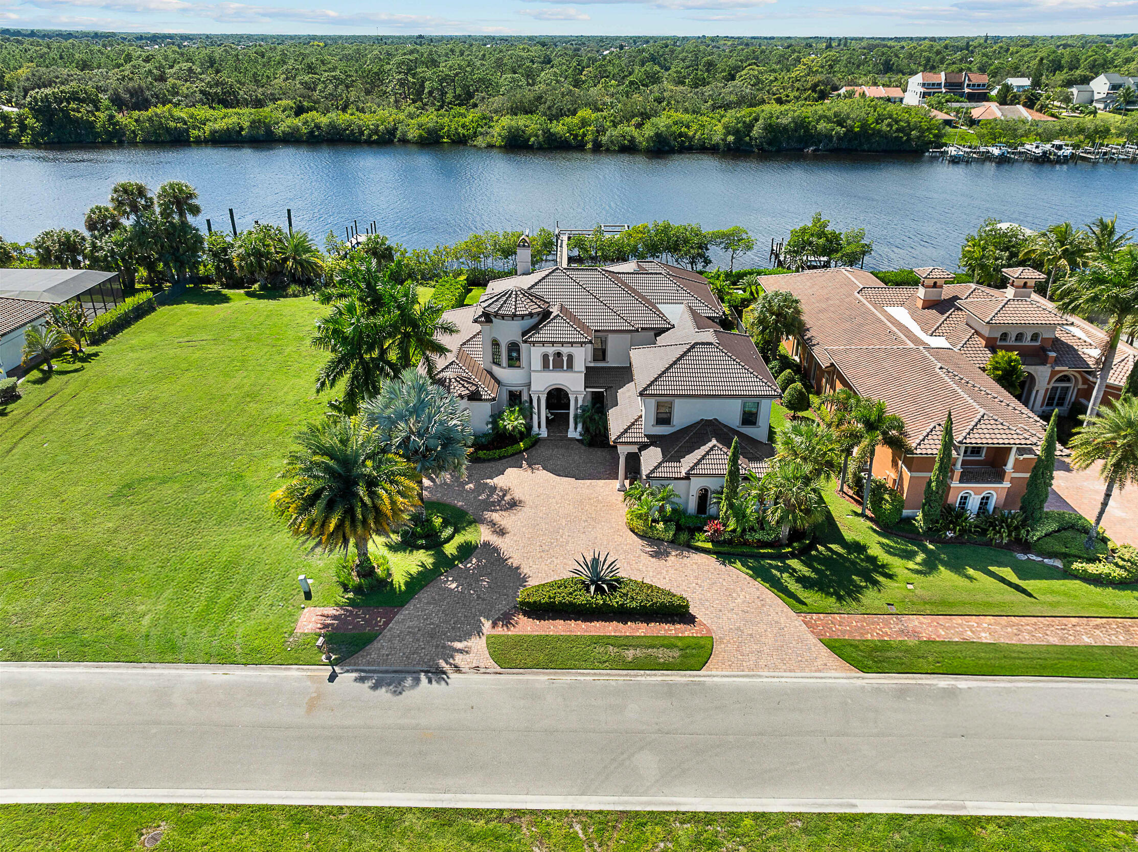 Discover true luxury in this stunning Arthur Rutenberg Estate home, built in 2014 with every detail thoughtfully designed. Featuring 6 bedrooms, 7 baths, over 6,000sq ft of AC living space, this residence seamlessly blends elegance and comfort. A separate off the pool deck-currently a gym-offers endless possibilities as a studio, in-law suite, or game room. The outdoor oasis includes an oversized pool and spa, a pavilion-style patio, and a fully equipped summer kitchen, perfect for entertaining. Enjoy tranquil views of the St. Lucie River's North Fork and a beautifully landscaped yard. The updated dock is suitable for a large yacht. Inside, formal & casual living areas surround a magnificent kitchen, while a home theater and an expansive master closet elevate the lifestyle. New 2025 Roof! With natural gas and exquisite finishes throughout, this home is lavish yet inviting. Truly a masterpiece that must be seen to be appreciated. All sizes, taxes approx.