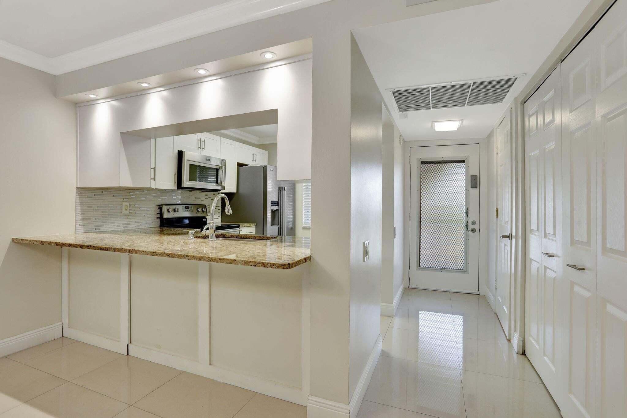 Beautifully updated 1BR / 1.5BA condo in desirable Wynmoor Village, Coconut Creek. This move-in ready residence features 24x24 porcelain tile flooring, elegant crown molding, smooth flat ceilings and walls (no popcorn), and an enclosed balcony overlooking peaceful garden views. The bright and spacious layout offers tasteful upgrades throughout and a comfortable living space perfect for relaxing or entertaining. Enjoy resort-style living with Wynmoor's exceptional amenities including golf, clubhouse, fitness center, pools, tennis, pickleball, theater, social clubs, courtesy transportation, and 24-hour gated security, all conveniently located near shopping, dining, and major highways.