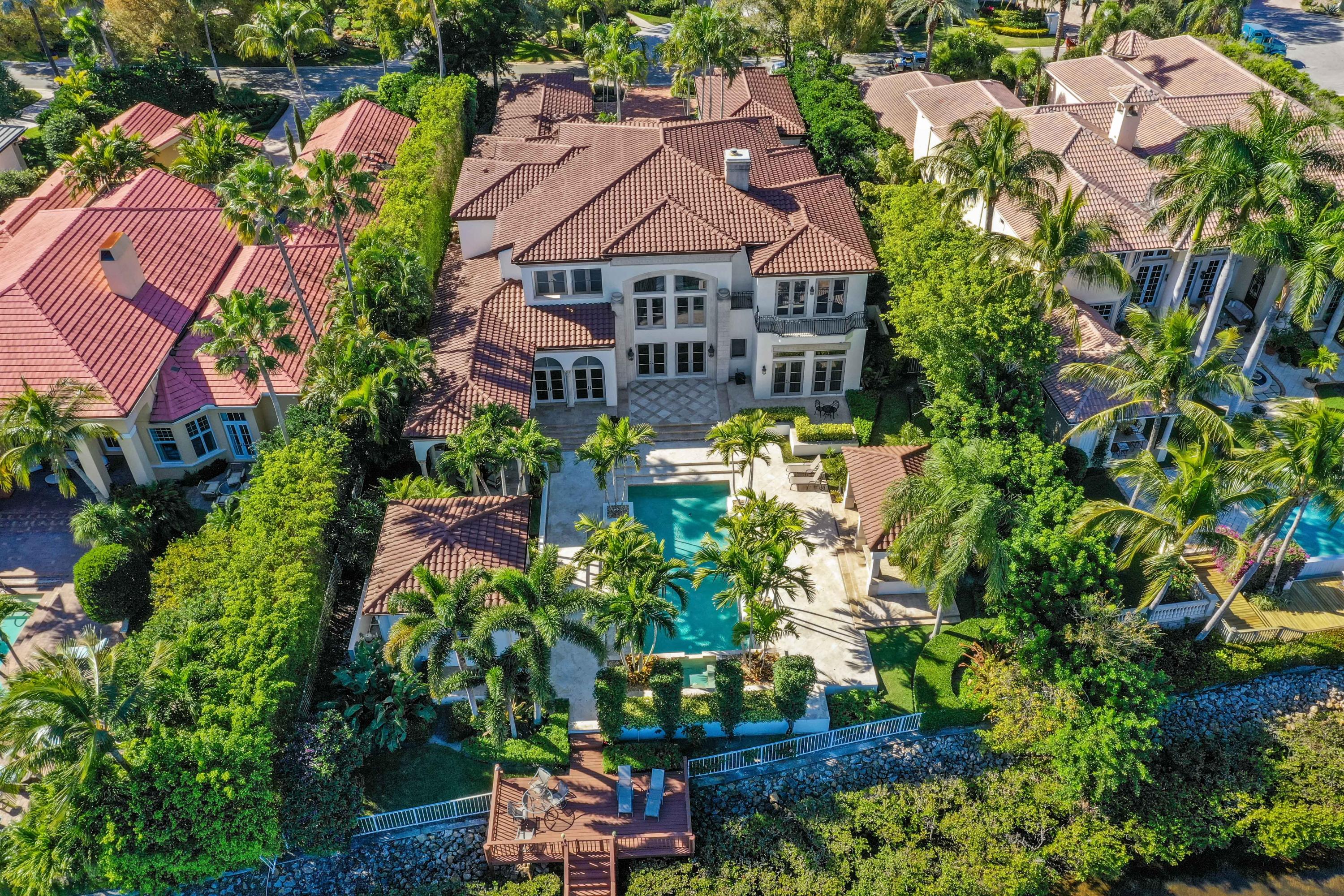 When you think of Admirals Cove in Jupiter, Florida, you visualize emerald fairways, pristine navigable waterways, luxury homes & amenities and a social life that will never leave you wanting for more. You can live this lifestyle here at 387 Eagle Drive. From the moment you drive through the Chicago Brick motor court, you'll realize you've found something unlike other properties in this price range. As you walk up to the giant red mahogany front doors and listen to the tranquil sounds of water cascading down the serene water fountain, you'll realize you've found your next place to call home. This concrete block home features impact windows and doors, concrete second floor, lush tropical landscaping, pool & spa and a dock that includes a boat lift and room for up to a 90ft yacht. Inside you will be overwhelmed by the large open spaces, the quality fit & finish and size of both the master and guest suites. Interior finishes include Level 5 Venetian Plaster walls, smooth texture ceilings, custom millwork package, Saturnia marble, hardwood and marble flooring, cast stone gas fireplaces and a new gourmet kitchen fit for a culinary chef including new custom cabinetry, Sub Zero & Wolf appliances and exotic granite countertops.

The back yard is where the magic happens. Sit at one of two covered areas, both with stainless grilling stations and both overlooking the pristine Admirals Cove waterways. This custom home may be one of the best waterfront estate home value in Admirals Cove.
