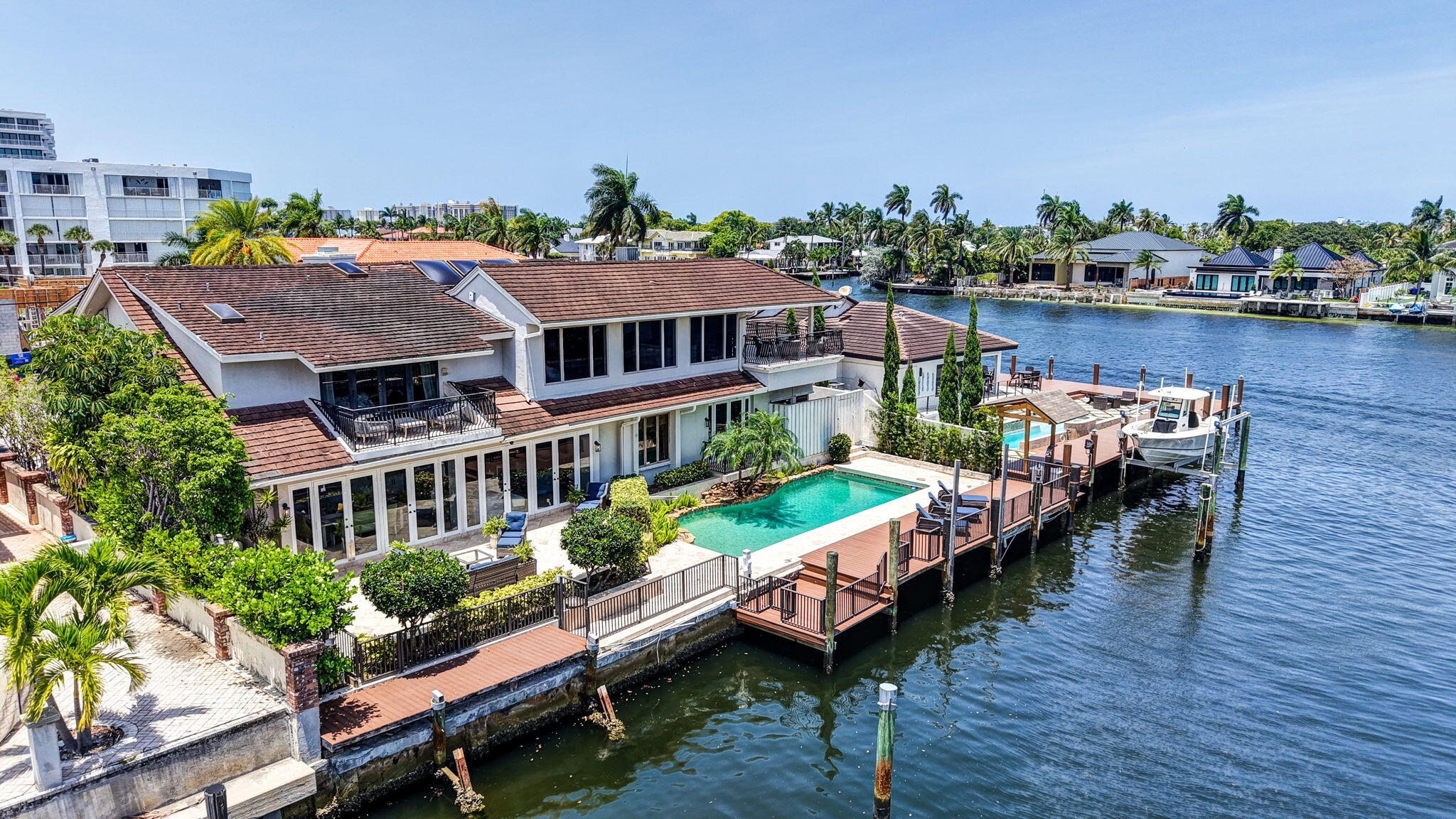 Amazing intracoastal views set this wonderful Coral Ridge deepwater home one off the intracoastal apart from the competition!  Enjoy the daily boat parade &  water views from the living room, kitchen, home office & primary suite plus upstairs bedroom suite & loft area (potential bedroom 5).  Private entry foyer unfolds to great room & fireplace with expansive vaulted & beamed ceilings, large updated kitchen, open to casual dining & living area. Upstairs includes 3 expansive bedroom suites & large loft entertaining area with bar, full bath & intracoastal facing balcony.  The views, Southern pool exposure & flexible floorplan must be seen to be appreciated.