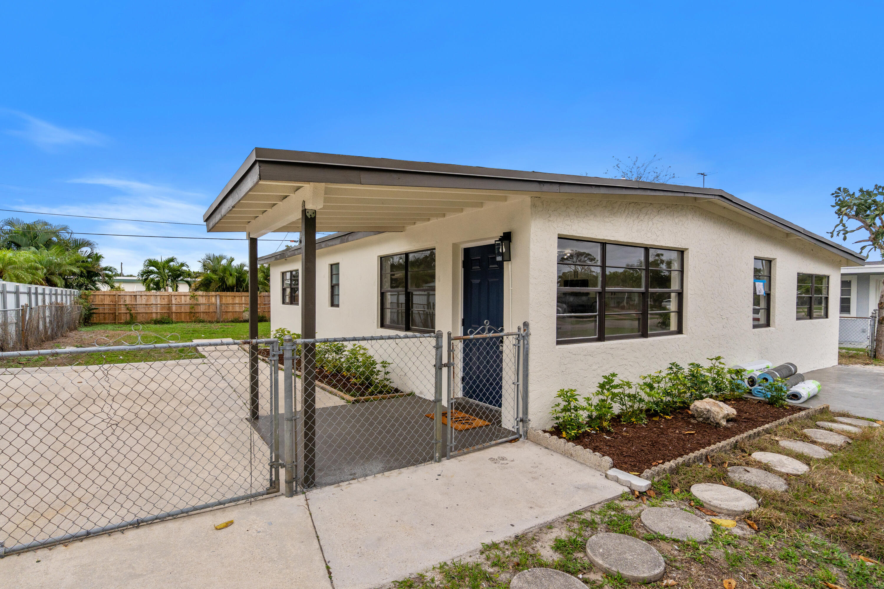 Move-in ready 3-bedroom, 2-bath single-family home available now in West Palm Beach! This beautifully renovated home features a modern kitchen with stainless steel appliances, updated bathrooms, laminate flooring, impact windows, central A/C, and a newer roof. Enjoy a spacious double driveway with plenty of parking and a large private backyard perfect for outdoor living. Located near the Florida Turnpike for easy commuting and zoned for the highly sought-after Joaquin Garcia High School. NO HOA, pet-friendly, and conveniently close to shopping, dining, parks, and everyday essentials. Easy move-in process and immediate occupancy available. Schedule your showing today!