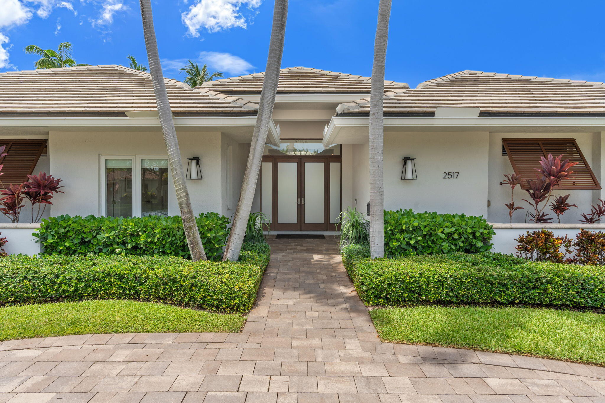 Experience refined living in the heart of Coral Ridge. Situated on a rare 100' x 130' corner lot, this exceptional one-story residence offers 4 bedrooms, 3.5 baths, and 3,566 square feet of beautifully designed living space. Originally built in 2004 and extensively reimagined with a down-to-the-studs renovation, the home showcases impeccable craftsmanship and timeless finishes throughout. Highlights include 10-foot ceilings, impact windows and doors, designer flooring, custom closets, and a spectacular chef's kitchen featuring Wolf and Sub-Zero appliances centered around an oversized island perfect for entertaining. Walls of glass fill the interiors with natural light while creating a seamless g connection to the resort-style pool and lush outdoor living spaces.  A private ececutive office with double pocket doors offers the ideal work-from-home retreat, separate from the bedroom wing. Multiple living and dining areas provide effortless flow for both intimate gatherings and large-scale entertaining. Every detail—from the newer roof and luxury baths to the landscaping, fencing, and driveways—has been thoughtfully curated to create a move-in-ready residence in one of Fort Lauderdale's most sought-after neighborhoods.