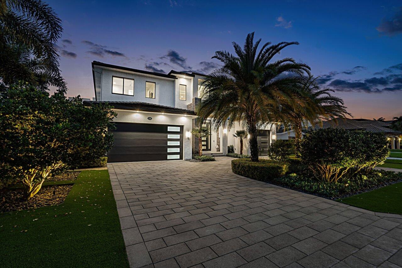 This newly built, architect-designed masterpiece is a rare find, blending modern luxury with thoughtful functionality. Showcasing a spectacular open-concept floor plan, this five-bedroom estate includes a detached guest home, offering incredible versatility as a private retreat, in-law suite, or studio. Crafted by East Boca's premier builder, this estate is designed for both grand entertaining and intimate living.

Perfectly positioned in one of the most coveted locations in the neighborhood, this home sits far south, just moments from Boca Raton's premier shopping districts on Palmetto and the city's finest restaurants. Whether you prefer a leisurely bike ride or a scenic walk, the pristine beaches are just minutes away, allowing you to embrace the best of South Florida living. The first floor is designed for seamless flow, featuring a grand living and dining space, a state-of-the-art kitchen, a media room, and a private office. A versatile downstairs bedroom doubles as a sophisticated club room, perfect for entertaining with its stylish design and effortless access to the home's main gathering areas. A stunning glass-enclosed wine wall, a butler's pantry, car charging ports, an elevator, and a resort-style summer kitchen are just a few of the custom upgrades that elevate this home.

Upstairs, a spacious secondary living areacomplete with a built-in barprovides a perfect retreat. Four oversized ensuite bedrooms each offer private baths and walk-in closets, ensuring comfort and privacy. The primary suite is a sanctuary of elegance, featuring a spa-inspired bathroom with dual water closets, expansive custom closets, and a private balcony overlooking the lush backyard and pool.

Outdoors, a covered loggia with automatic roll-down screens creates the ultimate indoor-outdoor living experience. The beautifully curated front and backyard gardens are enhanced by luminescent landscape lighting, setting the stage for a serene and enchanting evening ambiance. The saltwater heated pool and spa are surrounded by meticulously designed tropical landscaping with artificial turf for low-maintenance beauty.

Built with convenience and peace of mind in mind, this estate is equipped with top-of-the-line mechanicals, including an on-demand gas hot water heater and three-zone air conditioning. A whole-home liquid-cooled generator ensures uninterrupted power, adding an extra layer of security and luxury. Move-in ready and built to impress, this estate defines East Boca luxury living.
