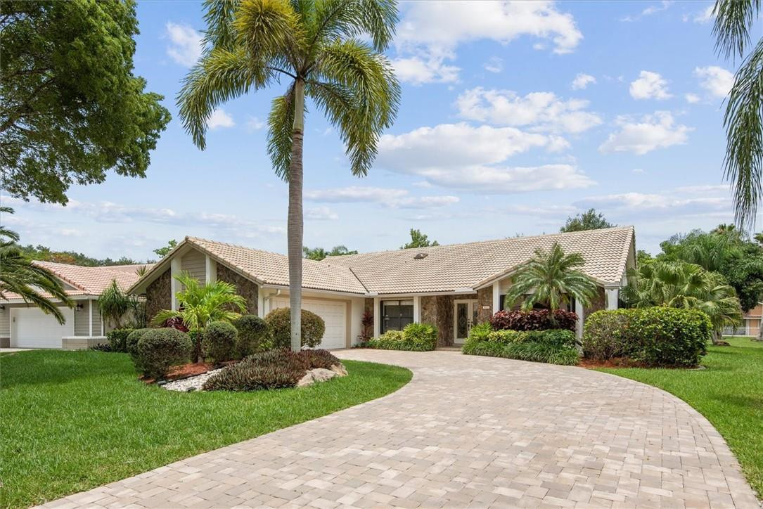 Premier Pine Ridge Waterfront Pool Home Awaits! Situated on a large 11,175 square foot lot. This home has been perfectly maintained by the long time owners, with features that include a split bedroom plan, beautiful kitchen with granite counter tops, 42" solid wood cabinets. Vaulted ceilings with new textured finish. Very nice tile flooring thru-out, new leaded glass front doors, new impact sliding doors in kitchen and family room, fully screened swimming pool with newer travertine deck, paver driveway and much more.  Low HOA. Great location! Shops, restaurants, hospitals, houses of worship and expressway all close by. Schedule your private showing today!