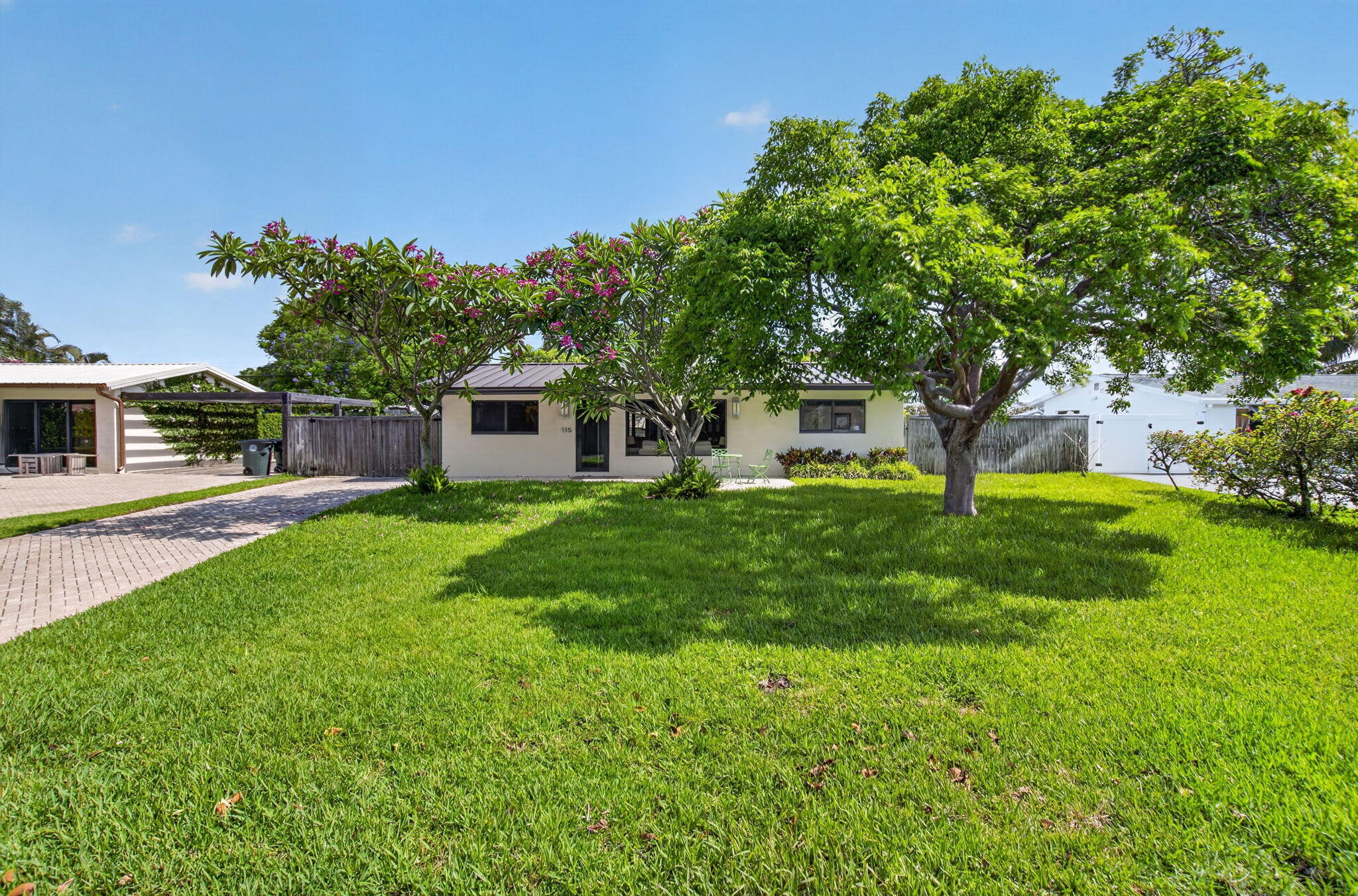 East Boca Retreat Near Mizner Park & Beaches Beautiful Spanish/Mediterranean-style cottage featuring a modern metal roof, tinted windows, and solar shades throughout. Ideally located in East Boca Raton, just minutes from Mizner Park, The Boca Raton Resort, downtown Boca, the Brightline, Boca Regional Hospital, schools, FAU and the area's beautiful beaches. This fully furnished turn-key 3-bedroom, 2-bath home comfortably sleeps six (2 queen beds and 1 full bed) and offers front and back patios, two HDTVs, and a laundry room with washer and dryer. The fully equipped kitchen includes a drip coffee maker, toaster oven, water/ice dispenser, dishes, silverware, pots, and pans. Additional conveniences include bath towels, beach towels, LED lighting throughout, and a NEST thermostat.  Enjoy the large private, fenced backyard, perfect for relaxing or entertaining. Available as a completely furnished or unfurnished annual rental, with furnishings thoughtfully provided both inside and outside the home. Experience the best of East Boca living with convenient access to fine dining, shopping, entertainment, golf, boating, and South Florida's renowned beaches.