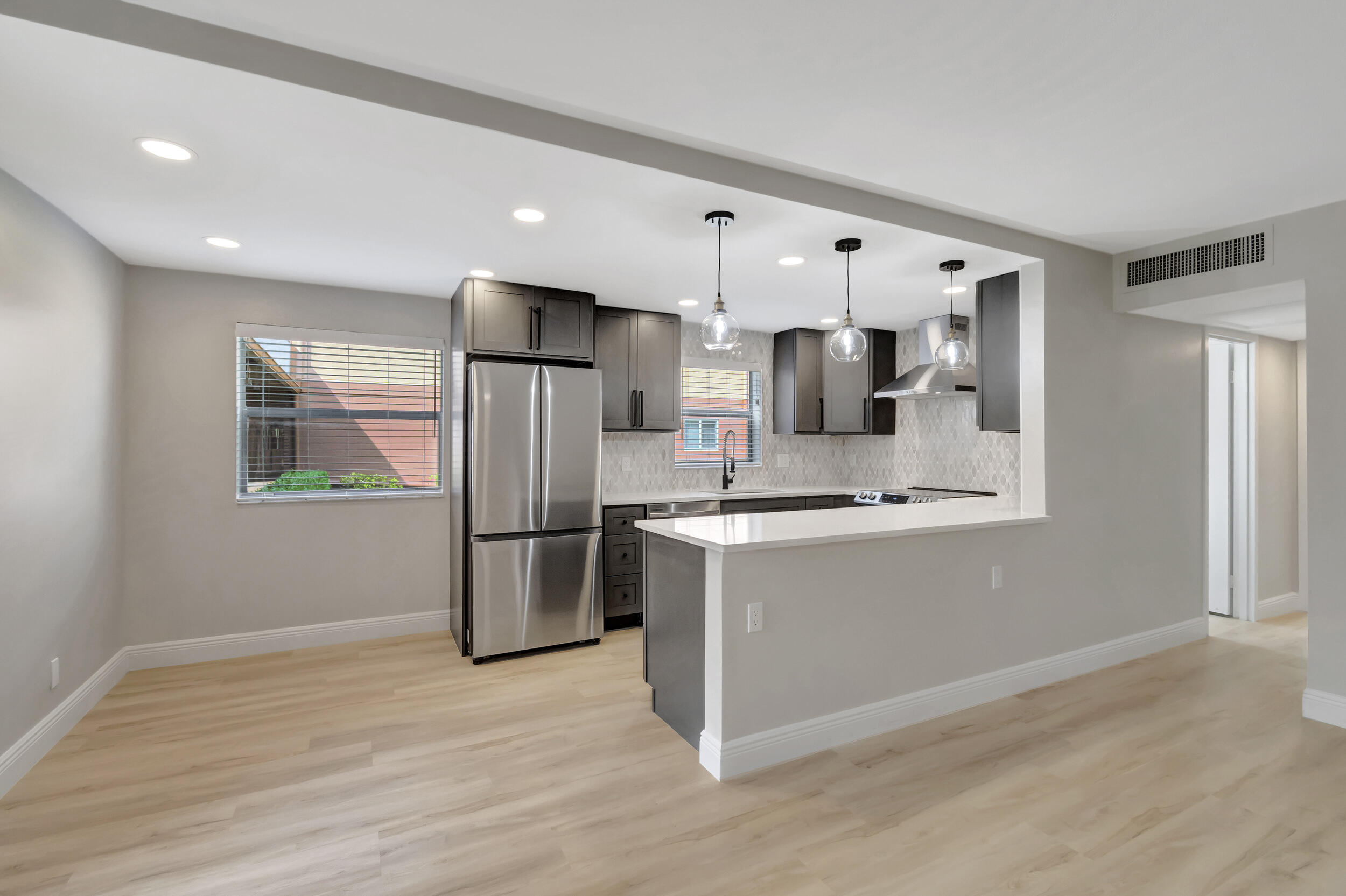 This move-in no-expense spared remodeled 2 bed 2 bath Saxony K condo is the perfect fit for everyone. Ground floor, custom kitchen with quartz counters, grey shaker style soft close cabinets and stunning marble backsplash make this kitchen top of the line,.Luxury vinyl floor planks throughout the living space, two custom bathrooms, both feature a walk-in shower made to suit each room. Primary bedroom has a walk in closet and remote ceiling fan.All appliances are new including a washer and dryer with storage closet on the covered patio. You'll love the amenities of Kings Point including two 18-hole golf courses designed by Robert Trent Jones, Sr.; swim & tennis, & exercise studio...Cafes in Monaco and main clubhouse adds Cap cont for this building $1992 to Saxony I.