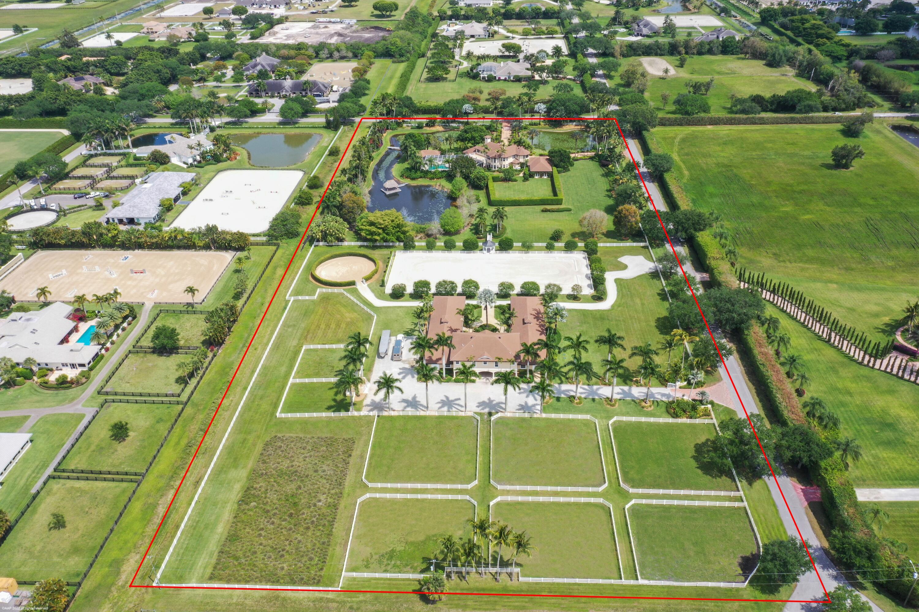 Private estate situated on 10.83 acres in the heart of Wellington's premier gated equestrian subdivision of Palm Beach Point.  The main residence has 4Br all w/ in-suite baths, plus a pool-side cabana suite w/full bath.  The home also boasts stone floors, center-island kitchen w/gas cooking, a spacious master suite with his & her offices & a home gym.  The riders in the family will love the beautifully landscaped 12-stall courtyard barn w/ 4 wash stalls, lounge, feed & tack rooms. There are 8 generous sized grass paddocks, round pen & 230' x 100' arena w/ world class footing lined by beautiful shade trees & viewing gazebo. The property lends itself to a covered arena and/or a grass grand prix field w/ the ability to have up to 24 stalls. Possibly the best deal on 10+ acres in Wellington! 3 Bedrooms on first level, Master suite is on the second floor, and there is a cabana suite with full bath off of patio.  
There are two 1BR apartments in the stables.
The roofs on house & stables were replaced in 2018.
Attached 3 Car garage 
The barn has hurricane windows.  The house has panels.
Pool is salt chlorination with electric heater.
There are generators - house and stables.
Two 500 gallon propane tanks at each generator.
RO Water Treatment system - Aqua Soft
Two septic systems - one at house & one at the stables both with risers for easy access.

The Grounds:
Ponds have re-circulators
Landscape up-lighting
Perimeter fencing has wire mesh for pets.
3 gated entries
Mature lush tropical landscape & gardens.
