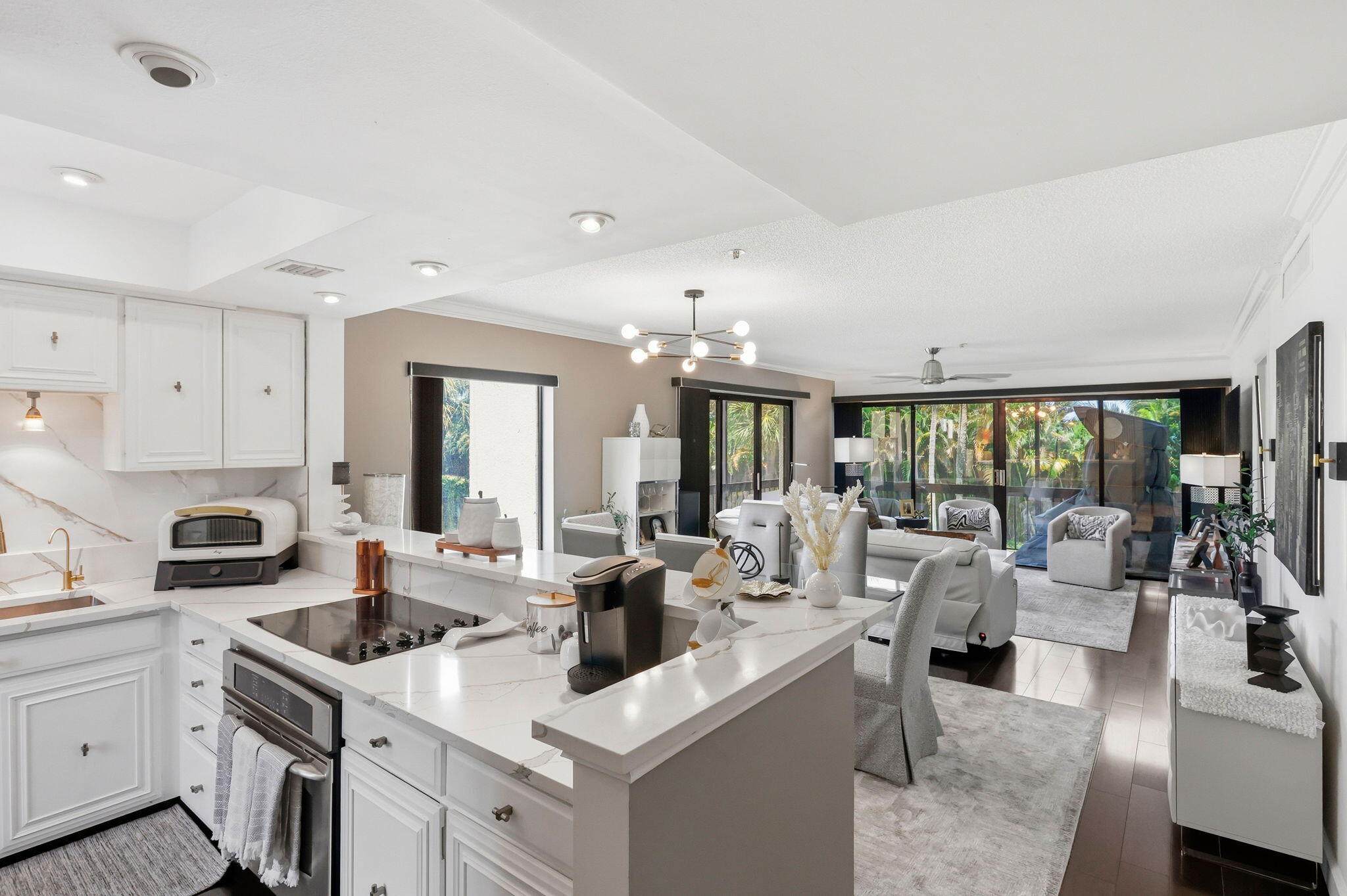 Welcome to effortless South Florida living in this beautifully updated 2-bedroom, 2-bath corner residence in the sought-after Lands of the President. Perfectly positioned with a spacious wraparound balcony, this light-filled home features an additional window and sliding glass door unique to its corner location, creating an open, bright atmosphere throughout.  The upgraded kitchen is designed to impress with quartz countertops, stainless steel appliances, and rich dark wood flooring, blending modern style with everyday functionality. The spacious primary suite offers a walk-in closet and a private ensuite bathroom, providing a comfortable retreat at the end of the day.  Ideally situated adjacent to the community pool while overlooking peaceful garden and lawn views, this residence offers  the perfect balance of convenience and tranquility. Just minutes from The Square, Palm Beach International Airport, beautiful beaches, Tanger Outlets, grocery stores, championship golf, and an incredible selection of restaurants and entertainment, you'll enjoy everything West Palm Beach has to offer right at your doorstep.  Negotiable furnishings make this an exceptional opportunity for a full-time residence, seasonal getaway, or investment. All that's missing is you.