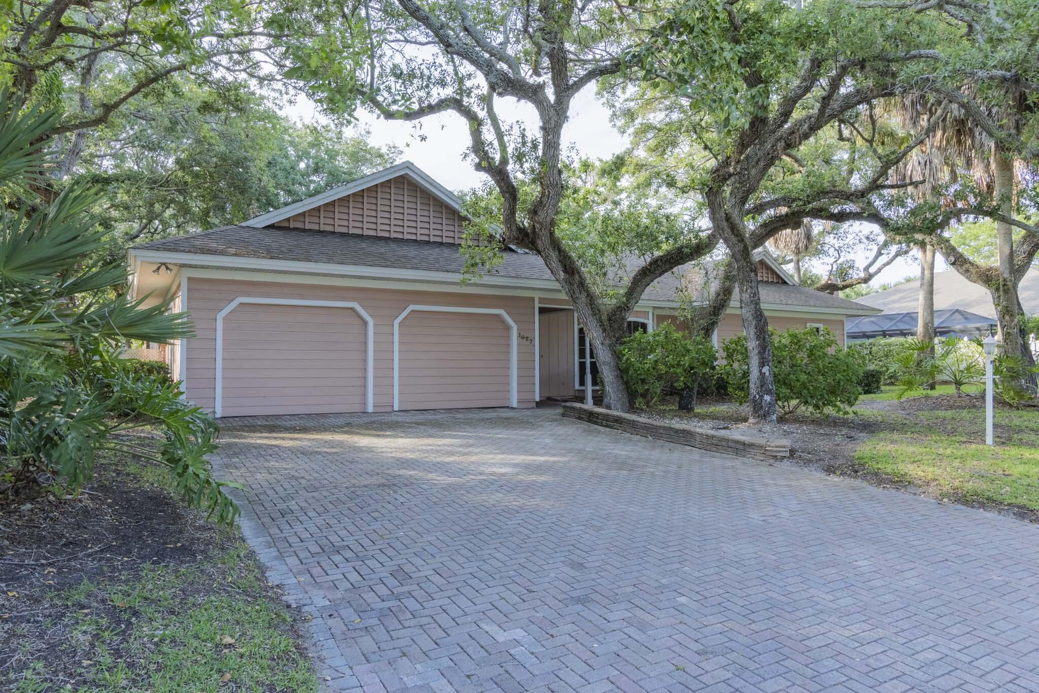 NOTE: This property is NOT for rent!!  Experience the best of island living in this spacious 1987 home, ideally situated in a community with a guarded gate. Open floor plan w/endless potential to customize & make it your own. Vaulted ceilings (some accented with wood) create a warm, airy ambiance, while multiple living spaces open to views of the screened-in 28x14 pool w/ outdoor shower. Mature trees & well-appointed neighboring properties enhance both the privacy & curb appeal. Enjoy deeded access to both the ocean and the river, offering opportunities for boating, beach & a true coastal lifestyle. Bring your vision & create your own paradise!  Original owners finally selling!!!  Pool resurfaced in 2020 and new pool pump in 2026! Room dimensions to be validated by buyer