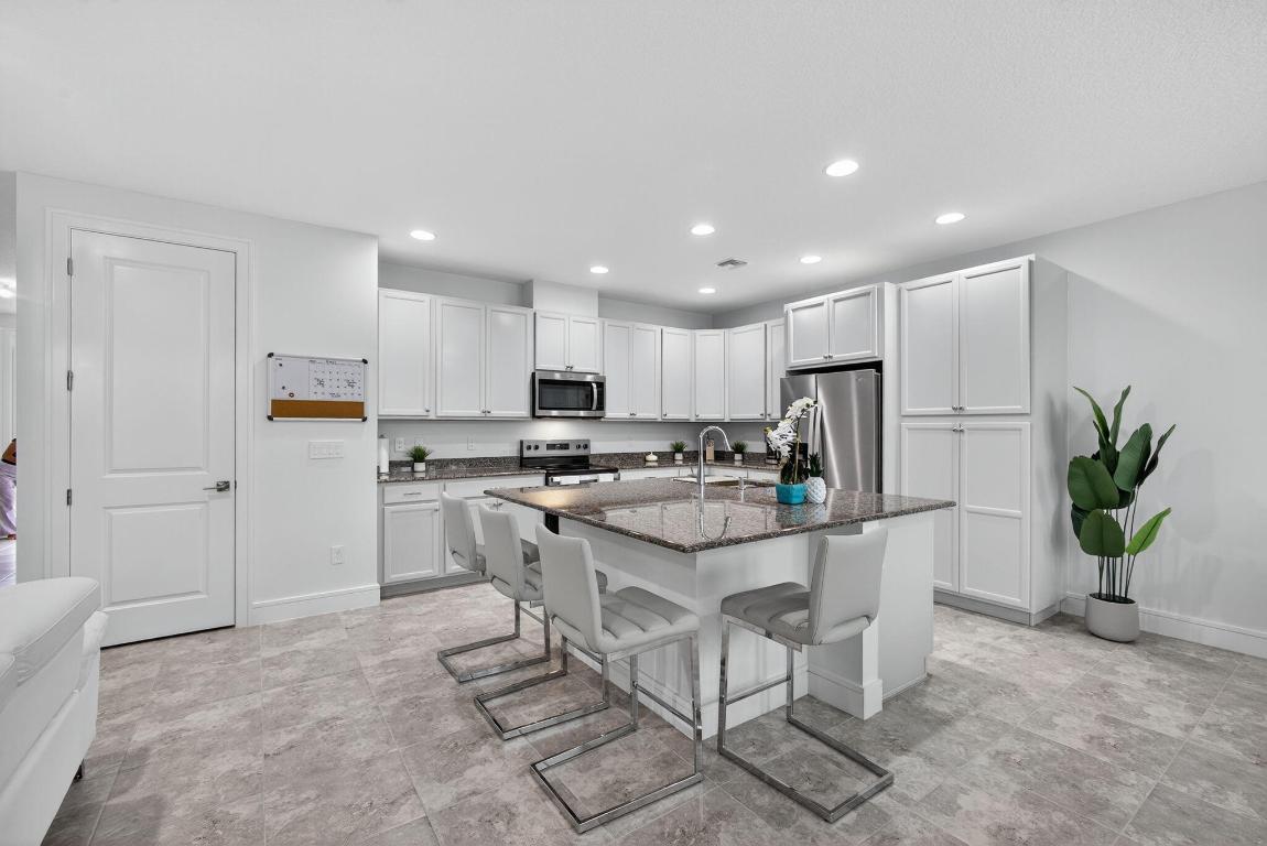 Modern Townhome in The Crossings at Westlake.
Welcome to this stunning 3-bedroom, 2.5-bath townhome, built in 2024 and thoughtfully enhanced with stylish upgrades and finishes. From the moment you step inside, you'll appreciate the attention to detail and modern design touches that make this home move-in ready. The spacious open floor plan is complemented by fresh designer paint, new baseboards, upgraded door casings, and sleek modern switch plates, creating a clean and contemporary look throughout. The primary bedroom features upgraded ceilings and walls, adding a touch of elegance and sophistication to your private retreat. Additional upgrades include epoxy flooring in the garage for durability and style, and impact windows throughout, offering peace of mind and energy efficiency. Life at Westlake means more than just a beautiful home...it means resort-style living at its finest. Whatever your favorite style of recreation, you'll find it at the Westlake Adventure Park. Swim in the lagoon pool, glide down the tower slide, or keep fit in the lap pool. Little ones will love the splash pad and adventure playground, while adults can relax in the shade or gather on the expansive lawns for parties and celebrations. With basketball courts, a dog park, an outdoor concert pavilion, and more, the amenities are truly unmatched, making Florida's new city the perfect place to call home.