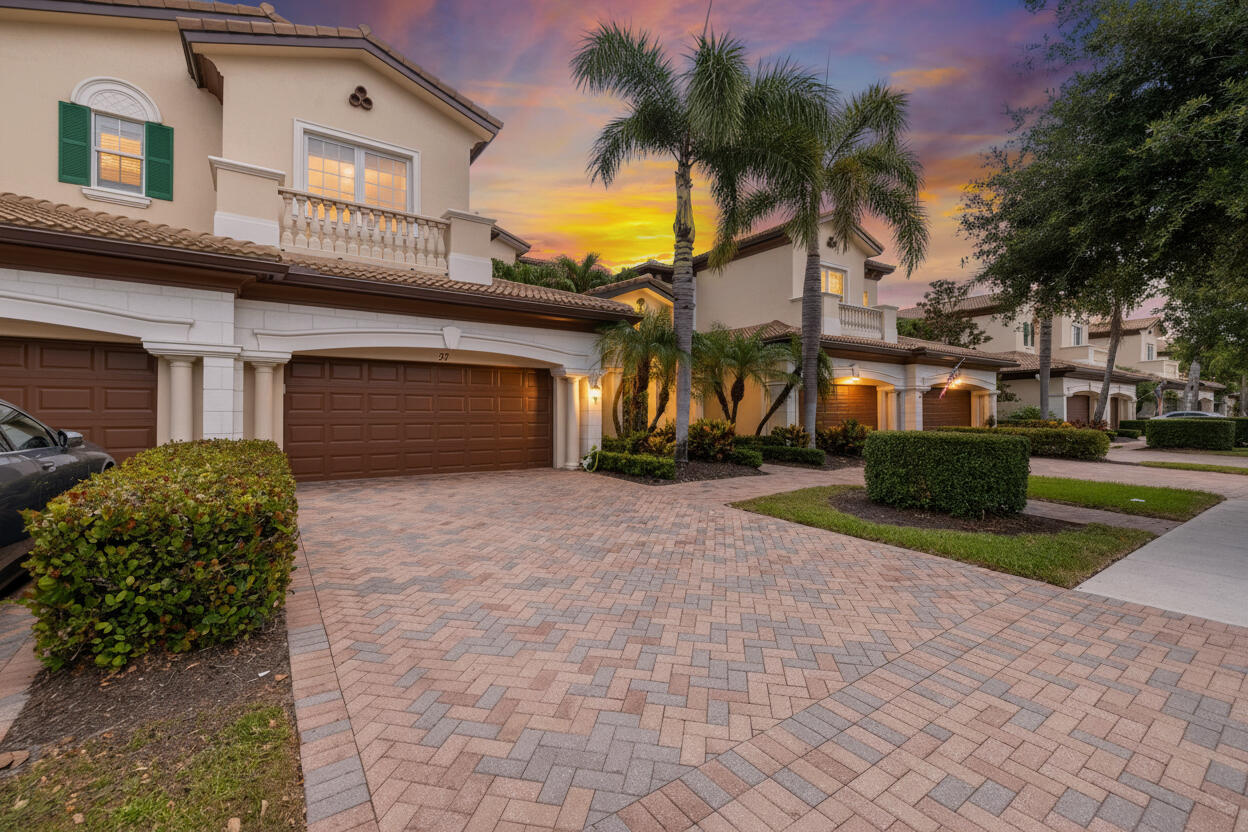 This stunning, updated, spacious ground floor corner unit offers 2 bedrooms plus a den/office, 2 bathrooms, and a 2 car garage. Perfect for someone who wants to enjoy the Florida lifestyle without elaborate maintenance. The home features ALL IMPACT WINDOWS AND SLIDERS, recessed lighting, elegant crown moldings, tray ceilings, plantation shutters, tile flooring, and hardwood in the primary bedroom. The open concept kitchen showcases a gorgeous oversized quartz island, a gas stove, stainless steel appliances, shaker cabinets, and a pantry. The primary suite offers a beautiful lake view and a large walk in closet. The en suite bathroom includes a corner tub, dual vanities, a separate shower, and a water closet. A separate laundry room includes a sink.  Enjoy the spacious, covered, screened in patio overlooking the serene lake. HOA includes exterior building insurance, cable, and internet. Jupiter Country Club offers an exceptional lifestyle with a Greg Norman-designed 18 hole golf course, two pools, a fitness center, tennis and pickleball courts, a playground, and more. A rated schools. It's conveniently located near shopping, dining, major highways, and just seven miles from the peaceful beach and Carlin Park. All measurements approximate. Please view the 3D virtual walkthrough.