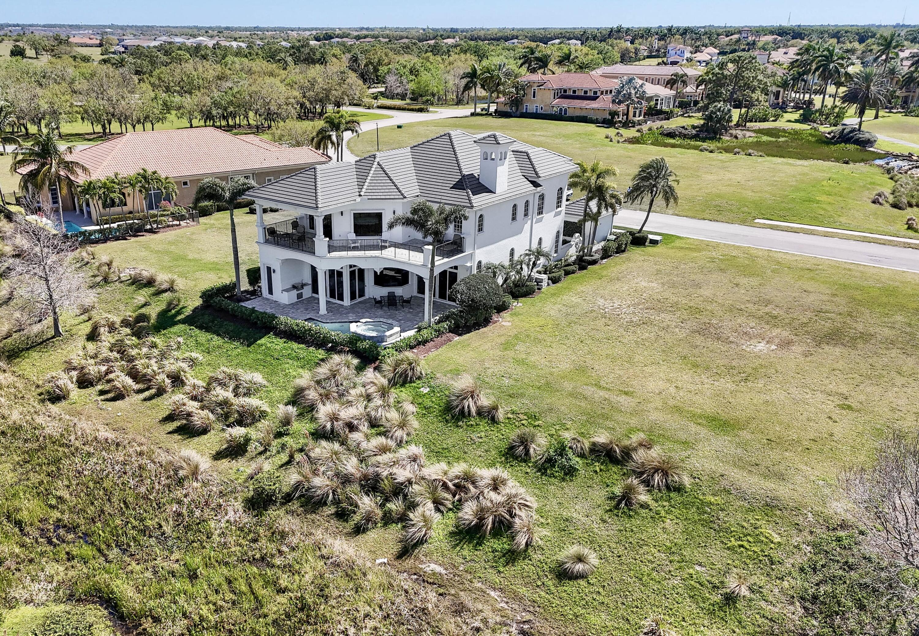 With dramatic views of the Palmer 6th & 7th golf holes, this open-concept home is lovingly updated, featuring 23-ft ceilings in the foyer & Living, a stone fireplace, new flooring, & large windows & doors, making the home bright. The family rm. & kitchen work seamlessly together, with a breakfast bar, glass & wood front cabinets, & Forno appliances. Main suite is spacious, with a private balcony & custom closet. The main bath features a new soaking tub with a spacious shower. The 1st-floor guest suite has a private bath & walk-in closet. Guest suites 2 and 3 have private baths. The den opens onto the private entry courtyard. The upstairs office/5th BR has large windows & detailed ceiling. Noted features: Formal Dining, Generator, Pneumatic Elevator, Spa/Pool. Club membership is optional. Tucked behind the gates of prestigious Tesoro Club on one of the community's most desirable preserve, water, and golf course homesites, this extraordinary residence offers something increasingly rare in today's luxury market—a home that has been extensively updated, remodeled, and modernized to today's luxury standards. Combining timeless details, excellent craftsmanship, and architectural character, this custom-built Modern Tuscan residence with an open feel is truly the best of both worlds. The result is a residence that offers the feel, beauty, and functionality that luxury buyers desire. Unlike new construction, which often entails delays, uncertainty, stress, and escalating costs, this home is ready today.    The updated Concrete-CBS construction design features a courtyard entry, a split golf-cart garage, a 2-car garage with an EV charger, large stormproof windows and doors, and a 2023 roof installation. The home has a natural gas generator, so you will never have to worry about being without power. In addition, both the front and backyard have been re-landscaped with new plants, and the driveway and sidewalk have been replaced. The entire backyard patio, including the pool and the summer kitchen, has been redone.  Inside, the home has also been lovingly remodeled, with new flooring, custom paint, and new  lighting, with every room updated, including all six bathrooms. At the heart of the home is the totally redesigned and significantly enlarged modern kitchen, which opens to the living room and family room as one huge great room, fabulous for entertaining. The kitchen has three levels of custom cabinetry, white and gold quartz countertops and backsplashes, premium stainless-steel appliances including an eight-burner gas range, double ovens, a new dishwasher, a beverage/wine cooler, and a Forno built-in double refrigerator and freezer. Truly a kitchen anybody would be proud of.   One thing that truly sets it apart from other fine homes is the incredible sweeping panoramic views of the water, the Palmer golf course (holes 6 and 7), and the preserve, which create a breathtaking backdrop from both levels of the residence. No matter whether you are relaxing in the spa or pool, or simply sitting outside on the private deck off the Main suite, drinking your morning coffee. You will be amazed by the tranquility, privacy, and exclusivity. The setting transforms everyday life into something special.  For buyers seeking the elegance of a custom residence, the convenience of modern living, and the peace of mind that comes from a truly turnkey residence, this is one of Tesoro's most compelling opportunities. Why wait?! Have it all today.