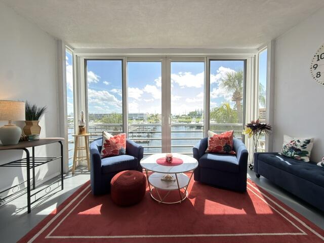 Enjoy stunning marina views and breathtaking sunsets from this beautifully furnished 3rd-floor condo in the highly desirable Ports O'Call community. Relax in the air-conditioned enclosed balcony while watching boats glide by.  This bright and inviting residence features a desirable split-bedroom floor plan with 2 bedrooms and 2 bathrooms, offering privacy and comfort for residents and guests alike. Natural light fills the home, highlighting the beautiful water views throughout. The tastefully furnished interior includes a comfortable sectional sofa, cozy seating, a king-size bed in the primary suite, and a queen-size bed in the guest bedroom.  Convenience abounds with a covered assigned parking space located just steps from the lobby entrance.  Ports O'Call is an active 55+ waterfront community offering exceptional amenities, including a clubhouse, heated pool, fitness center, storage closet, and day-use dock. Community boat slips are available for annual rental through a waiting list. Boating enthusiasts will appreciate the nearby Safe Harbor Marina with direct ocean access, all within walking distance.  Ideally located close to shopping, dining, beaches, and only 20 minutes from Palm Beach International Airport (PBI).   This turnkey condo is fully equipped with everything you need.  Available annually for $2,500 per month or seasonally for $3,000 per month with a 6-month minimum lease. Owner may consider a shorter seasonal term at a higher monthly rate. Rent includes cable, Wi-Fi, and water, making for effortless living  Just bring your suitcase and start enjoying the waterfront lifestyle, spectacular views, and resort-style amenities this exceptional condo and community have to offer.