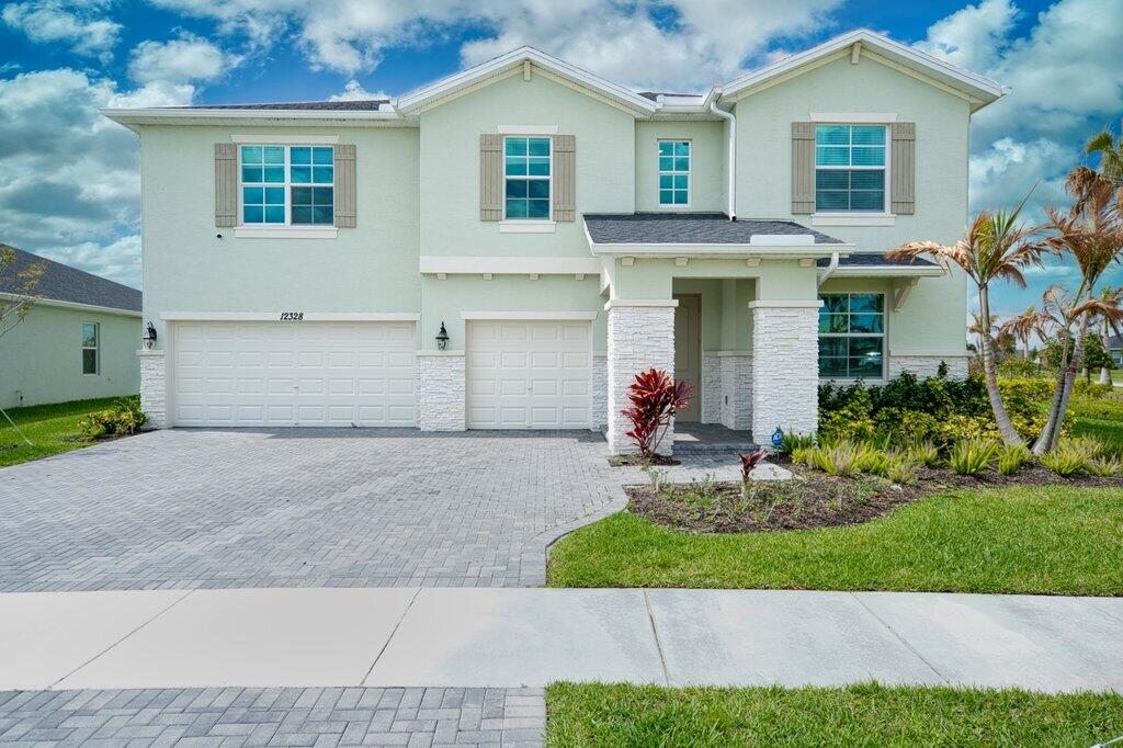 Experience elevated living in this 2024-built residence in the highly desirable Central Park community in Port Saint Lucie. This expansive two-story home offers 5 bedrooms, 3 bathrooms, and 3,734 sq ft of thoughtfully designed living space, blending modern style with everyday comfort.  Situated on a premium corner lot directly across from resort-style amenities, the home features a bright open-concept layout ideal for entertaining. Enjoy a screened-in patio overlooking an oversized waterfront backyard, complete with privacy bushes for a serene outdoor retreat.  The luxurious primary suite offers a private escape with a spacious en-suite bath and closet space. Additional bedrooms provide flexibility for family and a guest bedroom with full bathroom on the first floor.