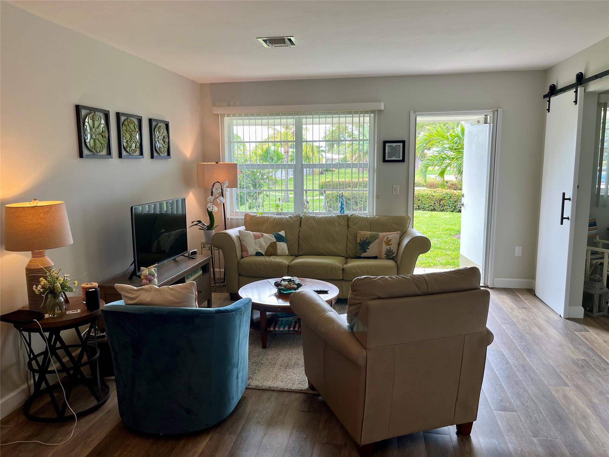 This charming & affordable unit is situated in a well-maintained 55+ community. This unit offers a cozy living space featuring a spacious kitchen, dining area, & living room with access to a serene back porch that overlooks a parklike setting. The unit offers two bedrooms, one of which is equipped with a barn door, a Murphy bed, & built-in closet space, making it versatile for use as an office, den, or guest room. The main bedroom is located near the  full bathroom with a jacuzzi tub.  New vinyl flooring. Pet-friendly complex. Additional amenities include two designated parking spaces, guest parking, a common laundry room, & extra storage space. The co-op has a low maintenance fees, no special assessments or land leases. Renting is not allowed during the first two years of ownership.